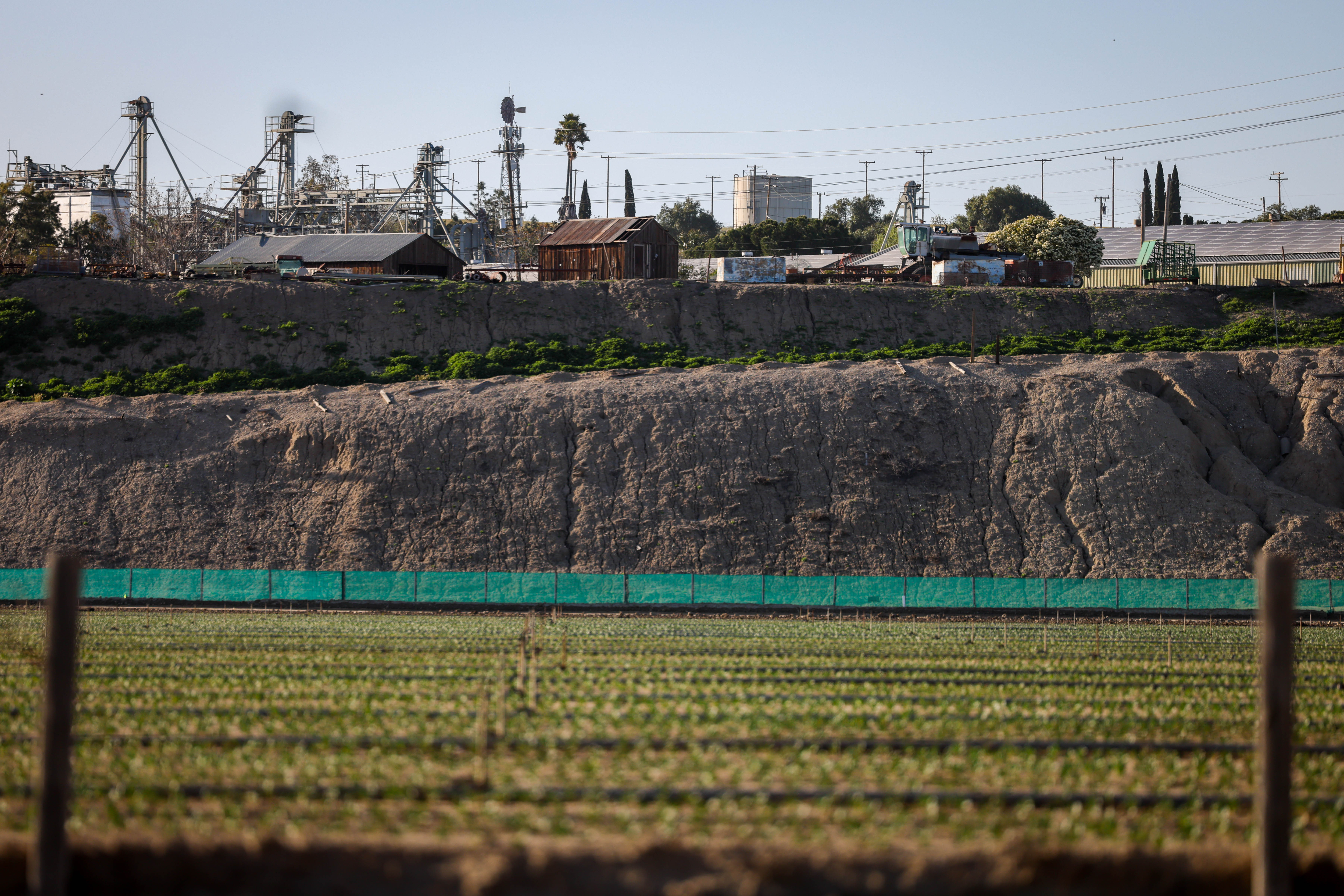 The water tank, far back center, that provides water from a Mission Ranches well, sits above San Lucas, Calif., on Thursday, April 14, 2023.