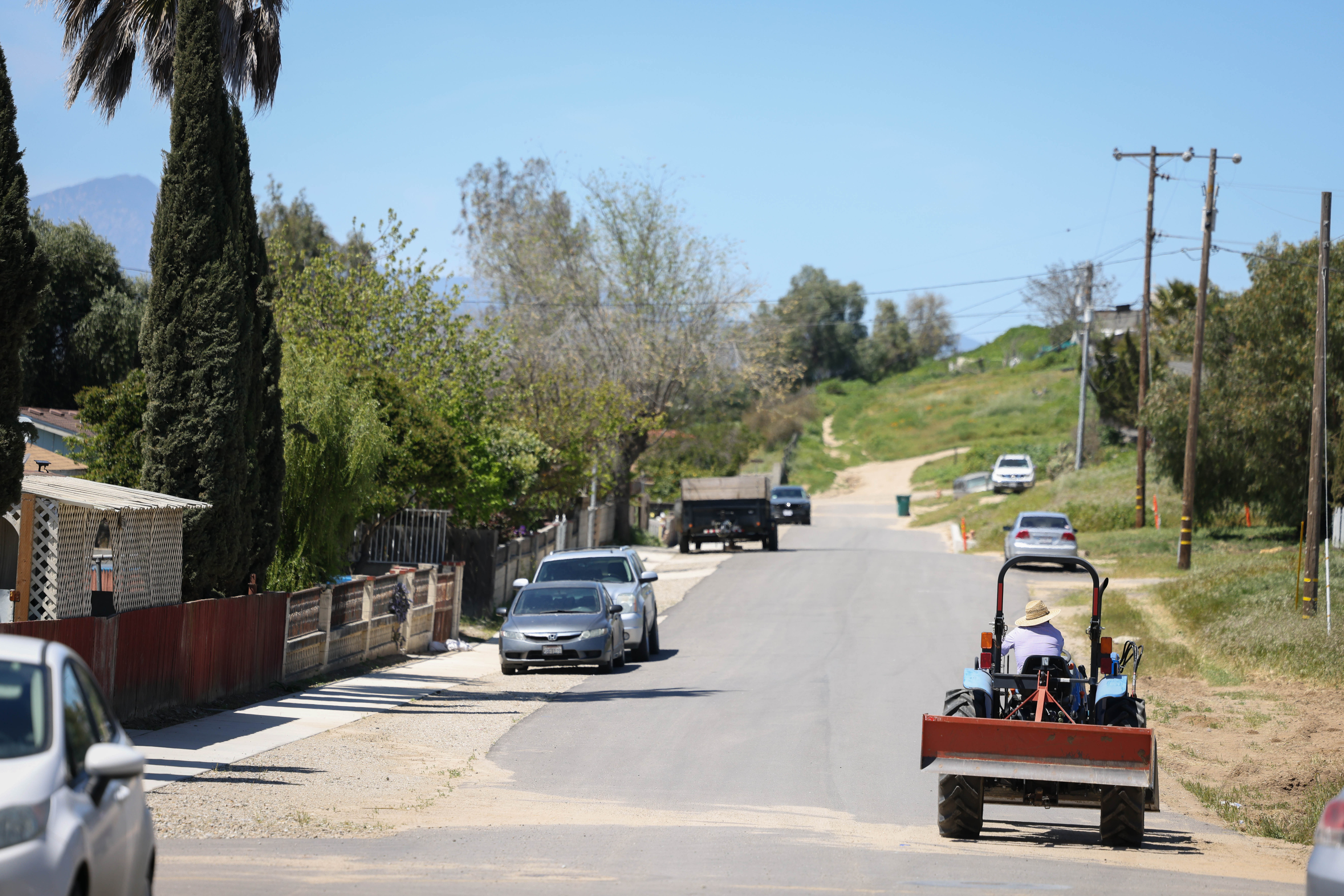 A tractor moves along San Benito Street in San Lucas, Calif., on Thursday, April 14, 2023.