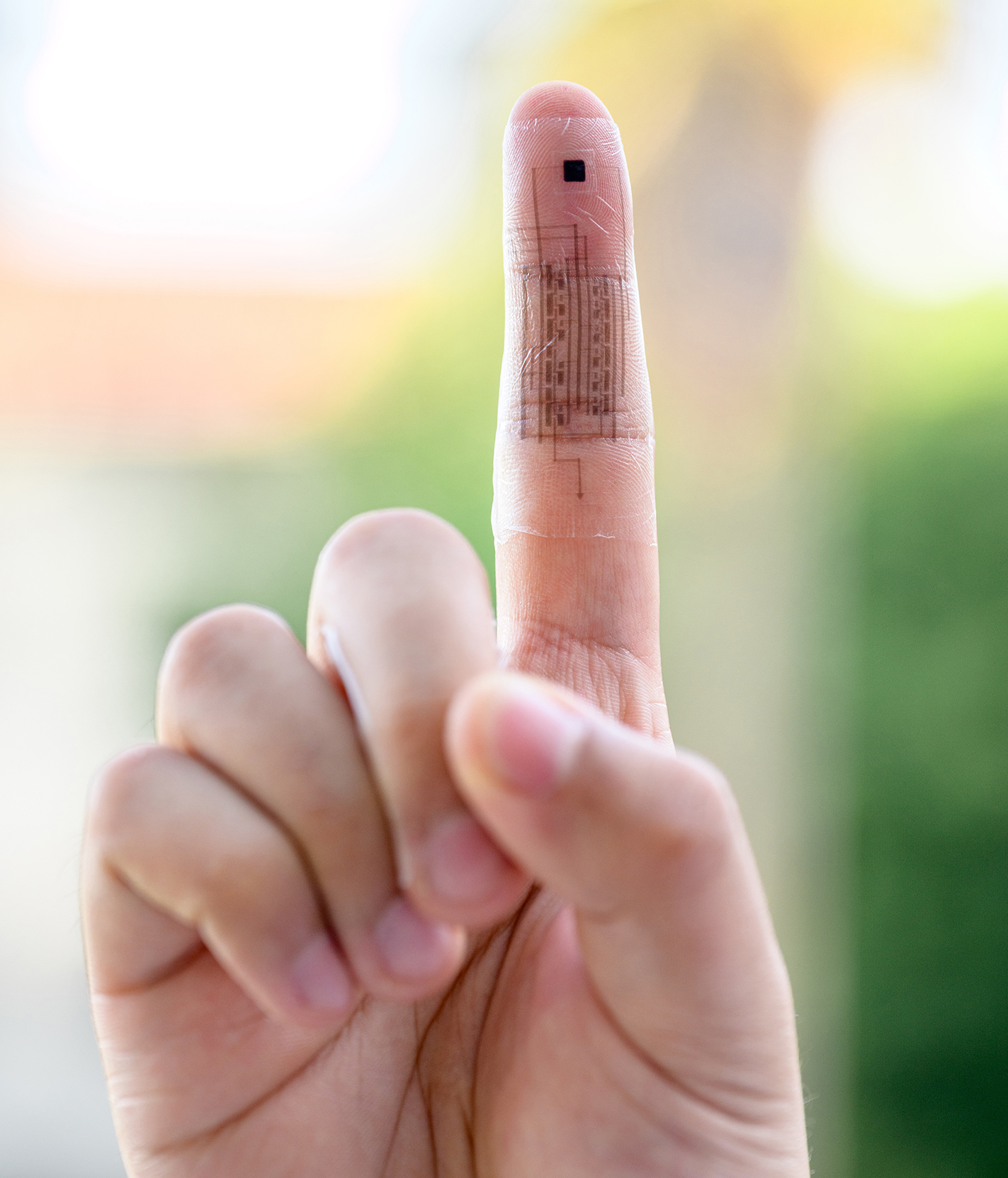 Photo of a soft e-skin attached to a finger. The biointegrated e-skin system consists of a temperature sensor, a pressure sensor, and two sets of RO-ED integrated circuits.. (Photo by Jiancheng Lai, Rui Ning)