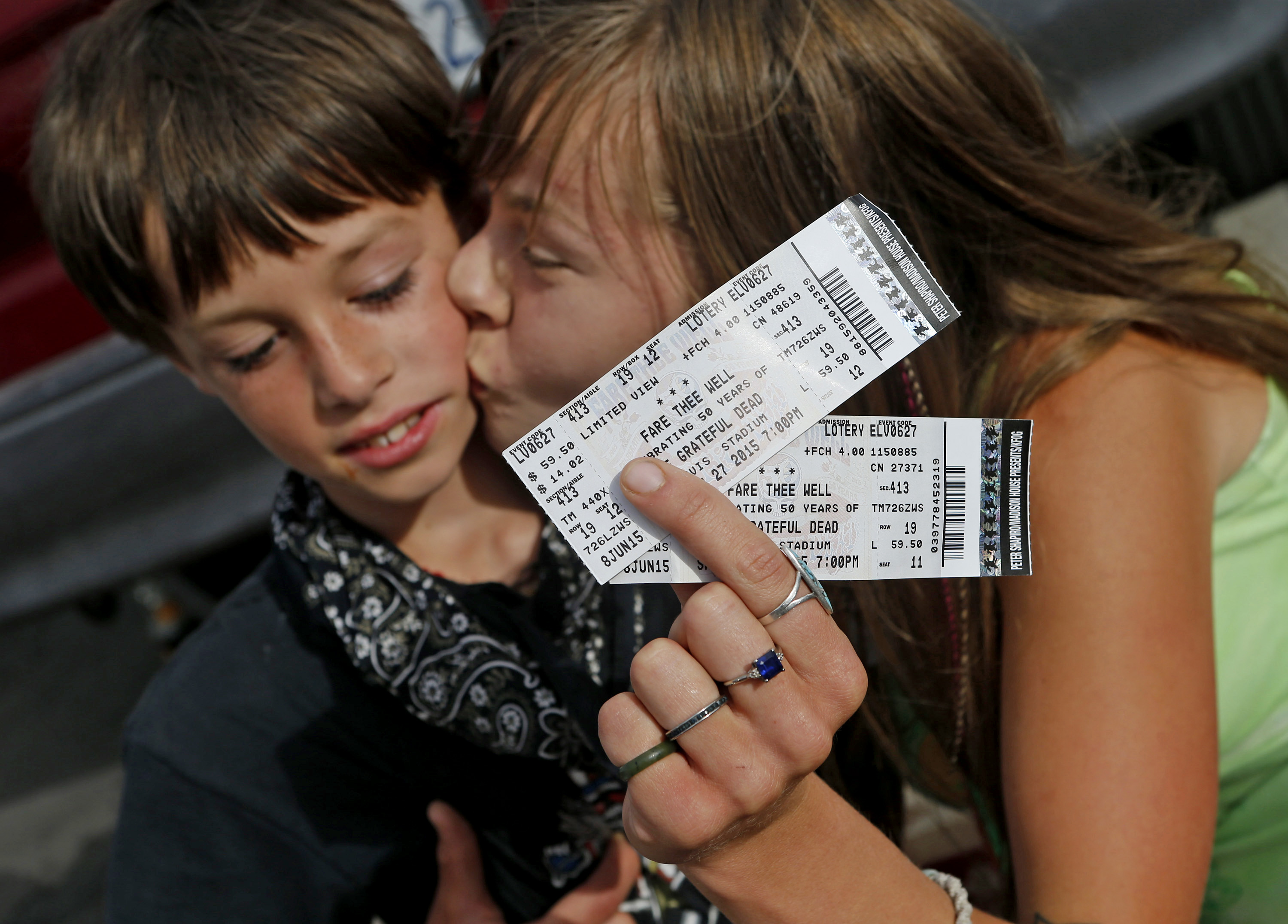 Telse Lagares, 26, of Eureka, kisses her son, Syris Gibson, 9, after a stranger gave them free tickets to a concert in Santa Clara, Calif., on Saturday, June 27, 2015.