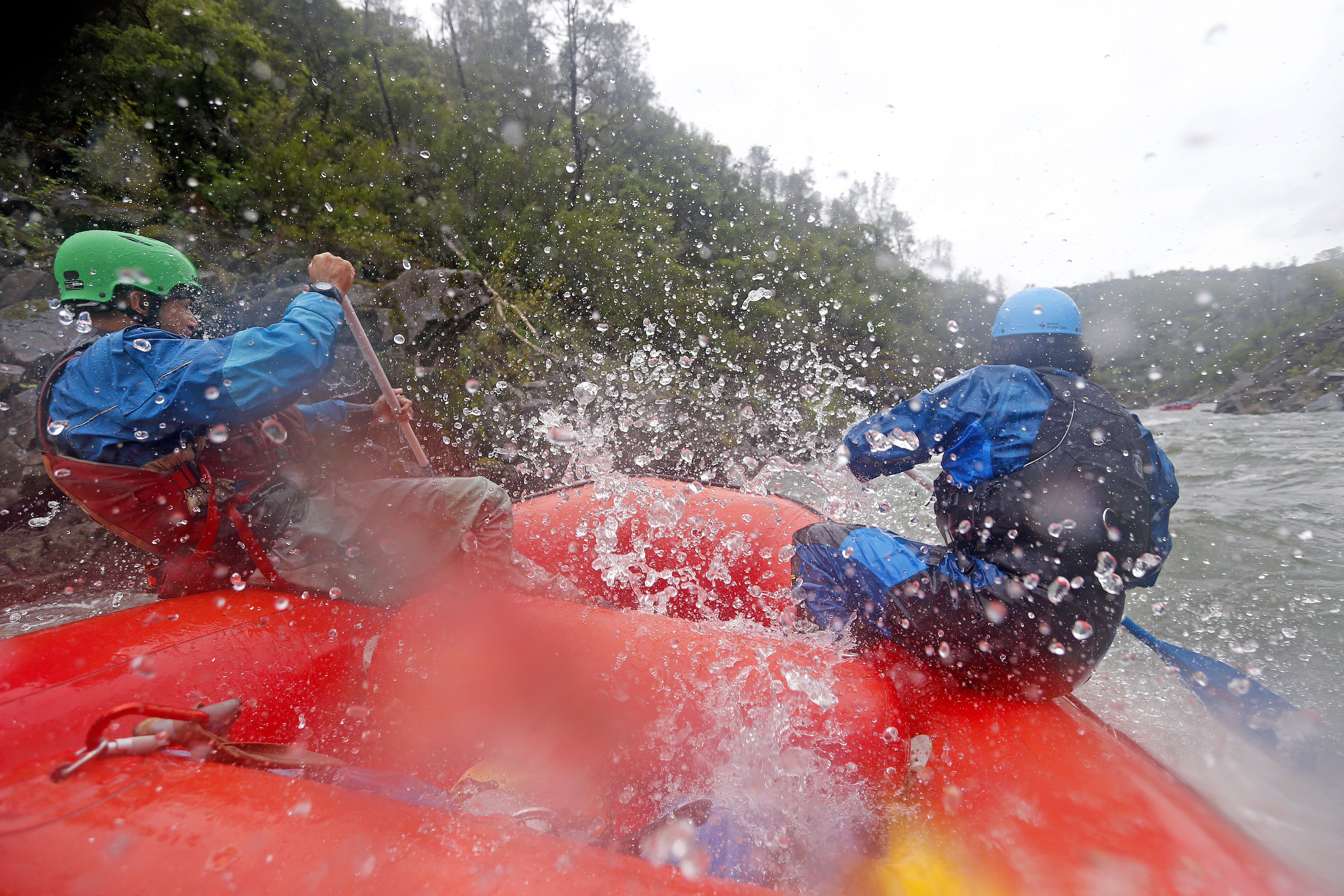 Guides Gilson Jonas, left, and Andres Suarez, right, with American Whitewater Expeditions raft down the South Fork of the American River on Thursday, May 4, 2023, near Coloma, Calif. (Aric Crabb/Bay Area News Group)