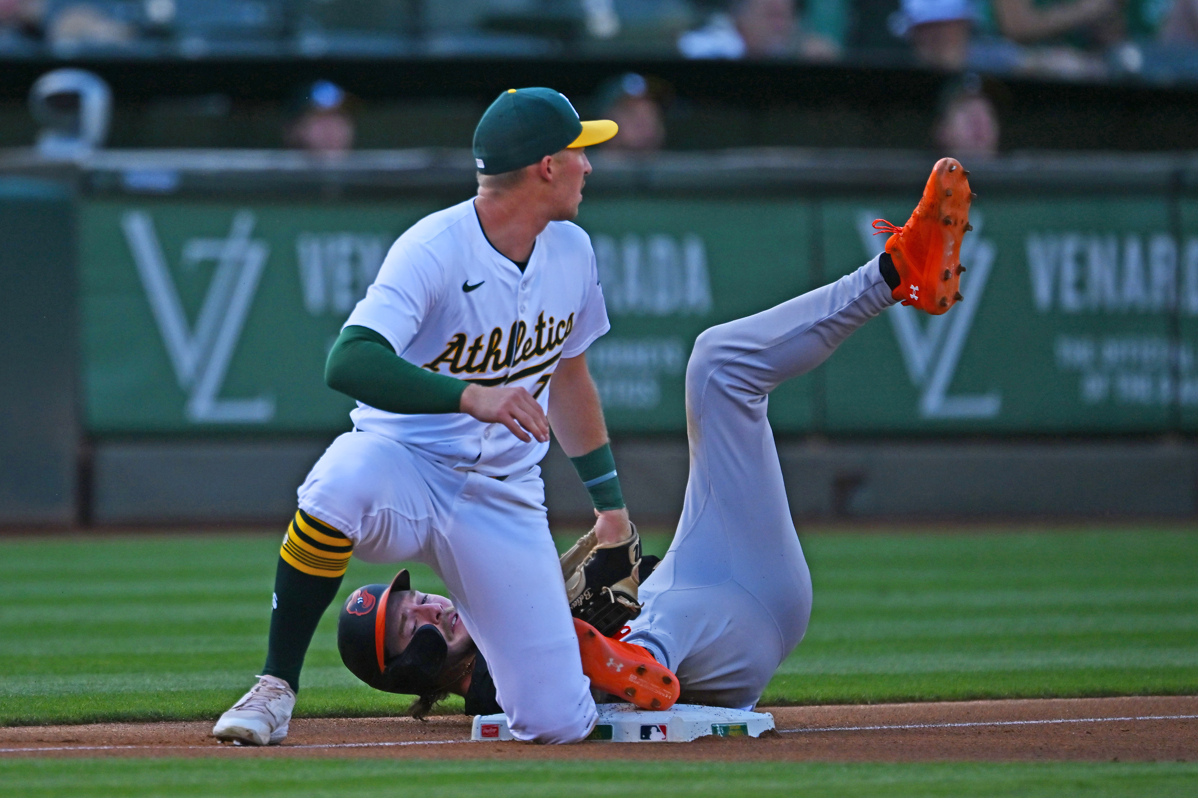 Baltimore Orioles' Gunnar Henderson (2) steals third base as Oakland Athletics' Brett Harris (77) looks to left field after missing the throw from the catcher during the first inning of their MLB game at the Coliseum in Oakland, Calif., on Friday, July 5, 2024. (Jose Carlos Fajardo/Bay Area News Group)