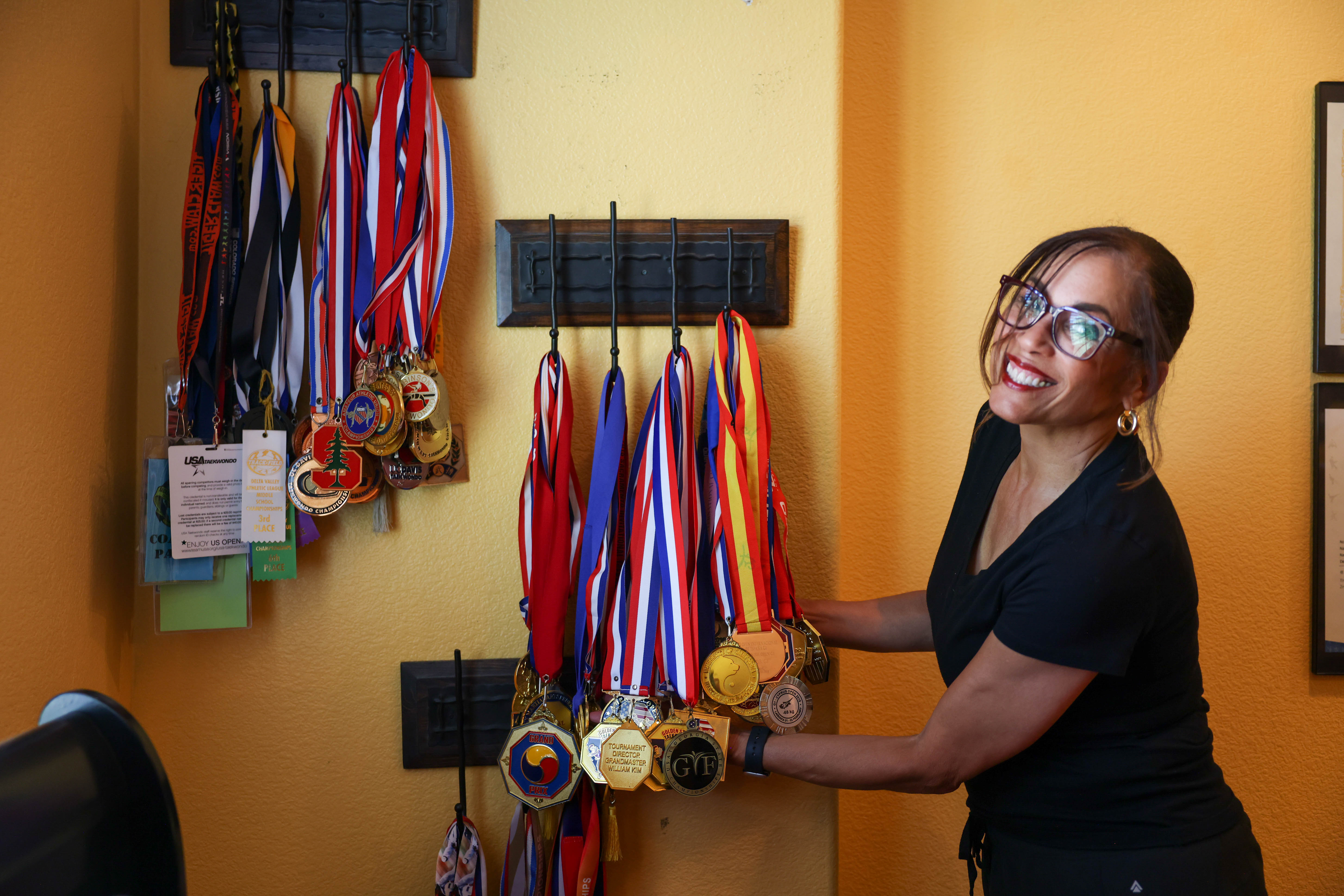 Denise Nickolas, mother of Olympian CJ Nickolas, shows dozens of medals her son has won in national and international Tae-Kwan-Do competitions displayed in his room in Brentwood, Calif., on Wednesday, July 3, 2024. Denise and her son got into the sport when he was 3. Both have competed in tournaments and just a few years ago, Denise won a national title as her son is already with the USA Olympic team heading to Paris. (Ray Chavez/Bay Area News Group)