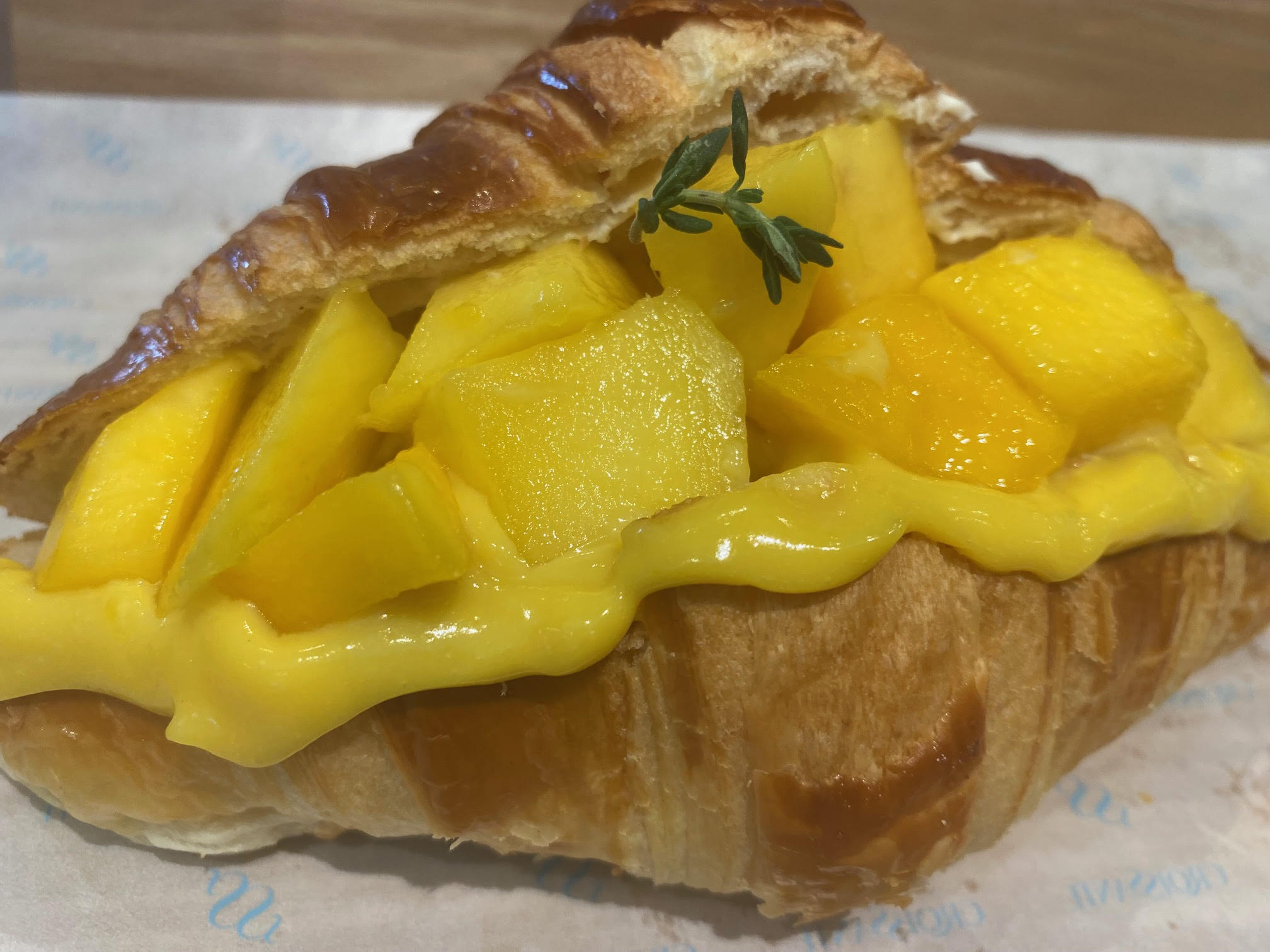 The Croissante bakery-cafe in Santa Clara turns croissants into full desserts. The Mango Croissant is filled with cream and topped with fresh mango and mango puree. (Linda Zavoral/Bay Area News Group)