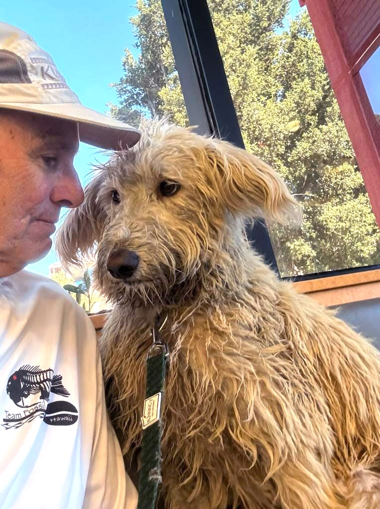 Good samaritan Roger Dunn, after rescuing an 8-month-old Goldendoodle named Leilani on Bair Island on Saturday, July 6, 2024. Dunn was canoeing when he heard what sounded like a howl. It turned out to be a dog owned by Kevin Dalonzo, a real estate agent from the Peninsula, who had been looking for her since being frightened by the sound of fireworks at a 4th July event at Redwood Shores. (Roger Dunn/FaceBook)