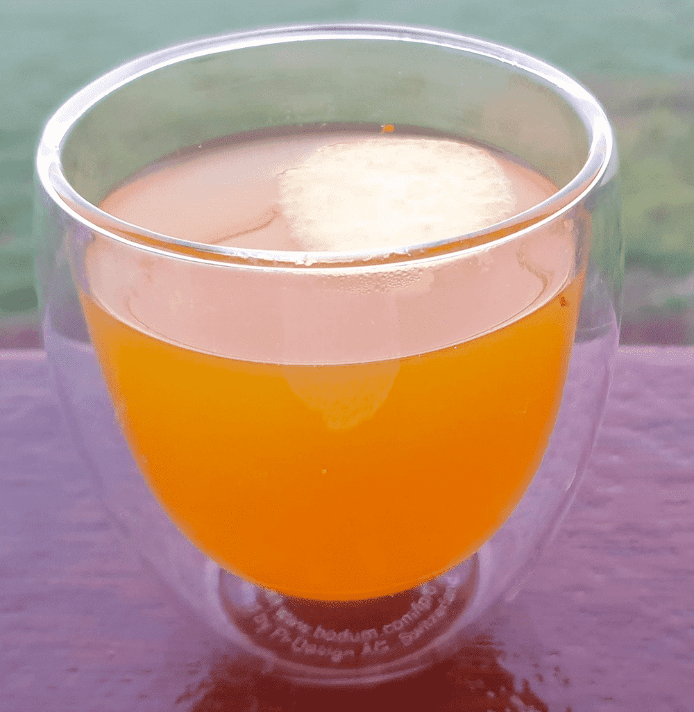 A glass of Hot Ginger Turmeric Toddy