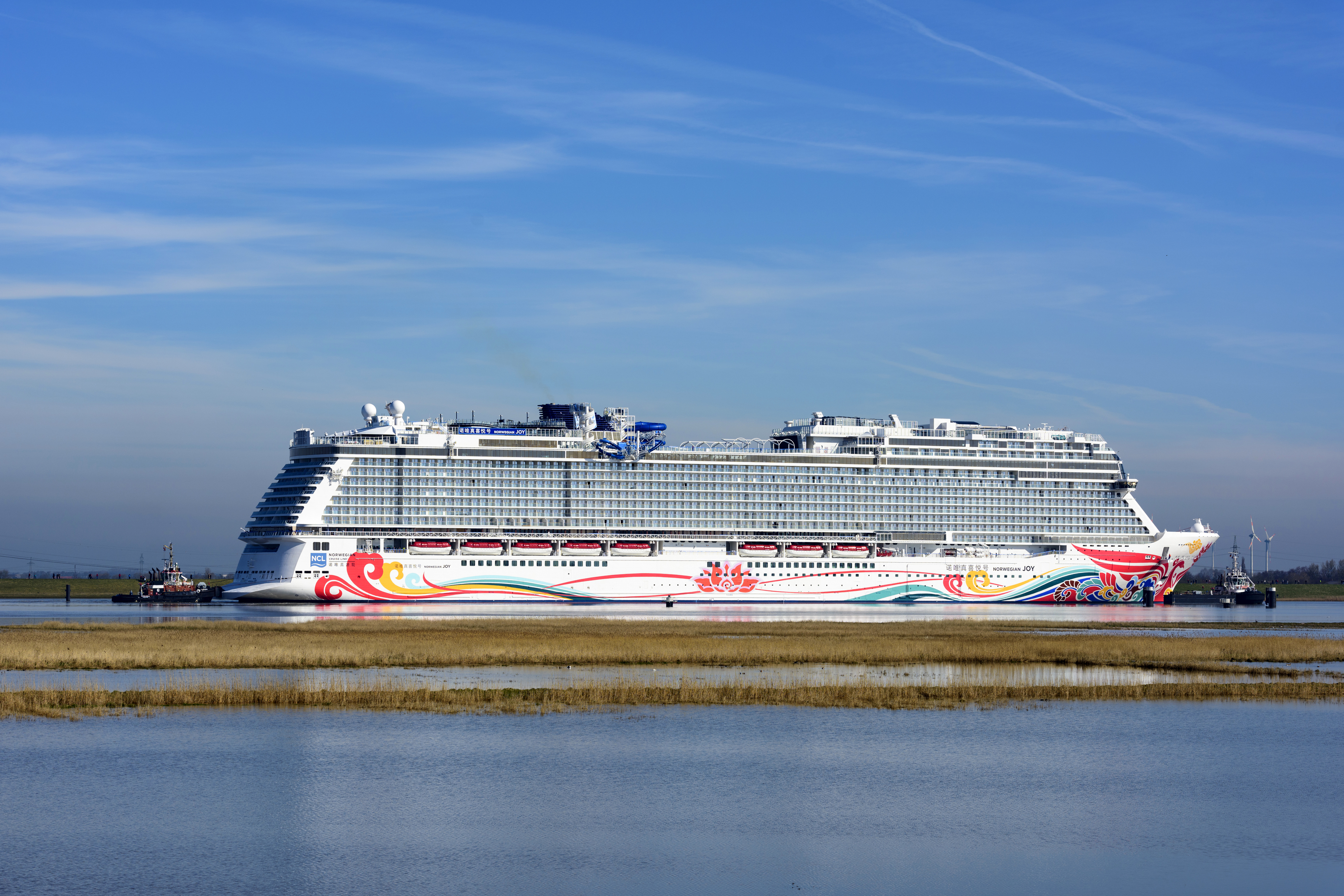 The 3,850-passenger, 168,800-gross-ton Norwegian Joy makes its way up the Ems River from Meyer Werft shipyards in Papenburg, Germany to Eemshaven, Netherlands before it begins sea trials in the North Sea in this 2017 handout photo. (Courtesy/Norwegian Cruise Line)- Original Credit: Norwegian Cruise Line - Original Source: Handout