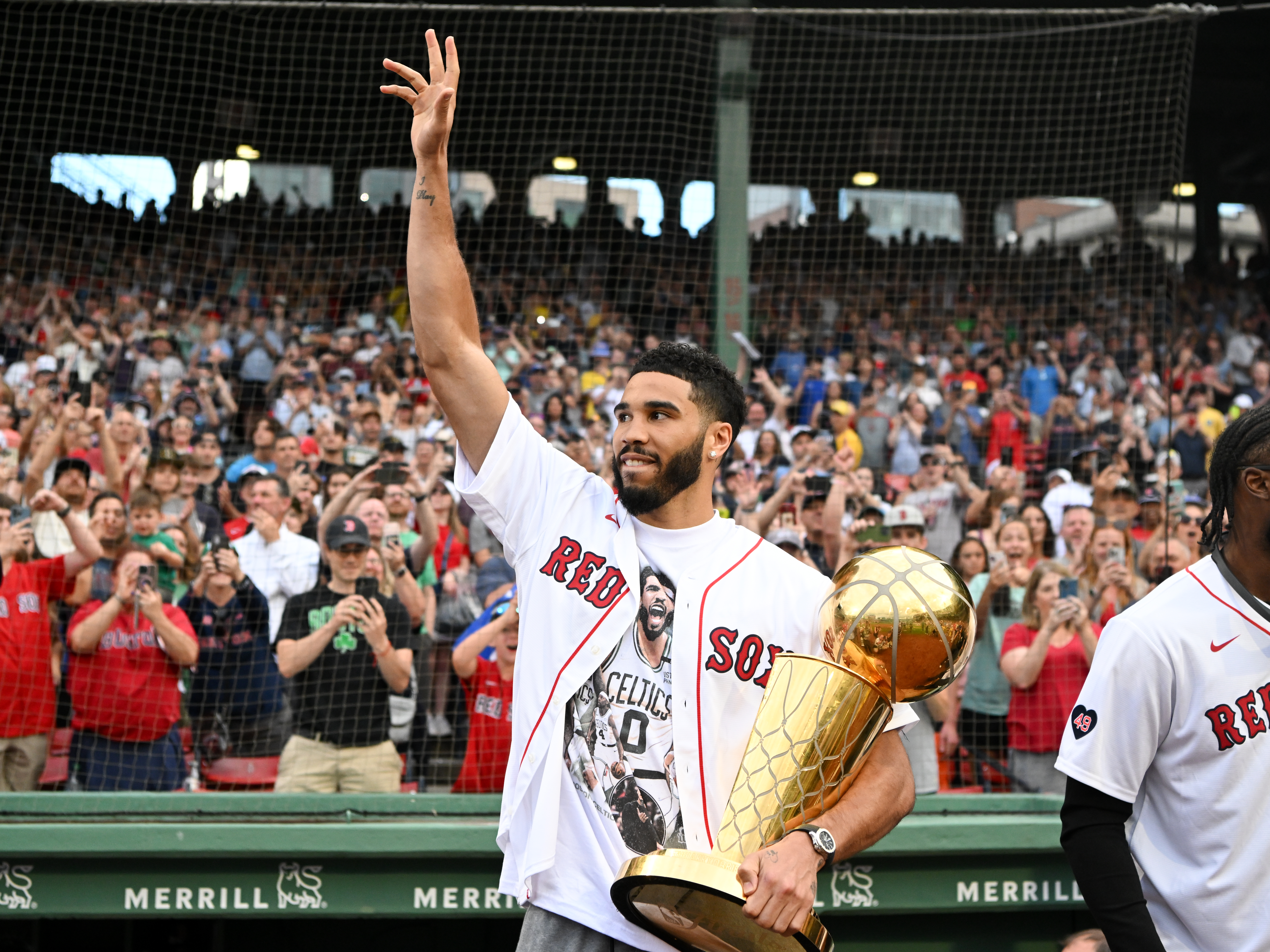 Jayson Tatum steps onto the field at Fenway Park for a pregame ceremony to honor the Celtics' 18th NBA championship. (Brian Fluharty/Getty)