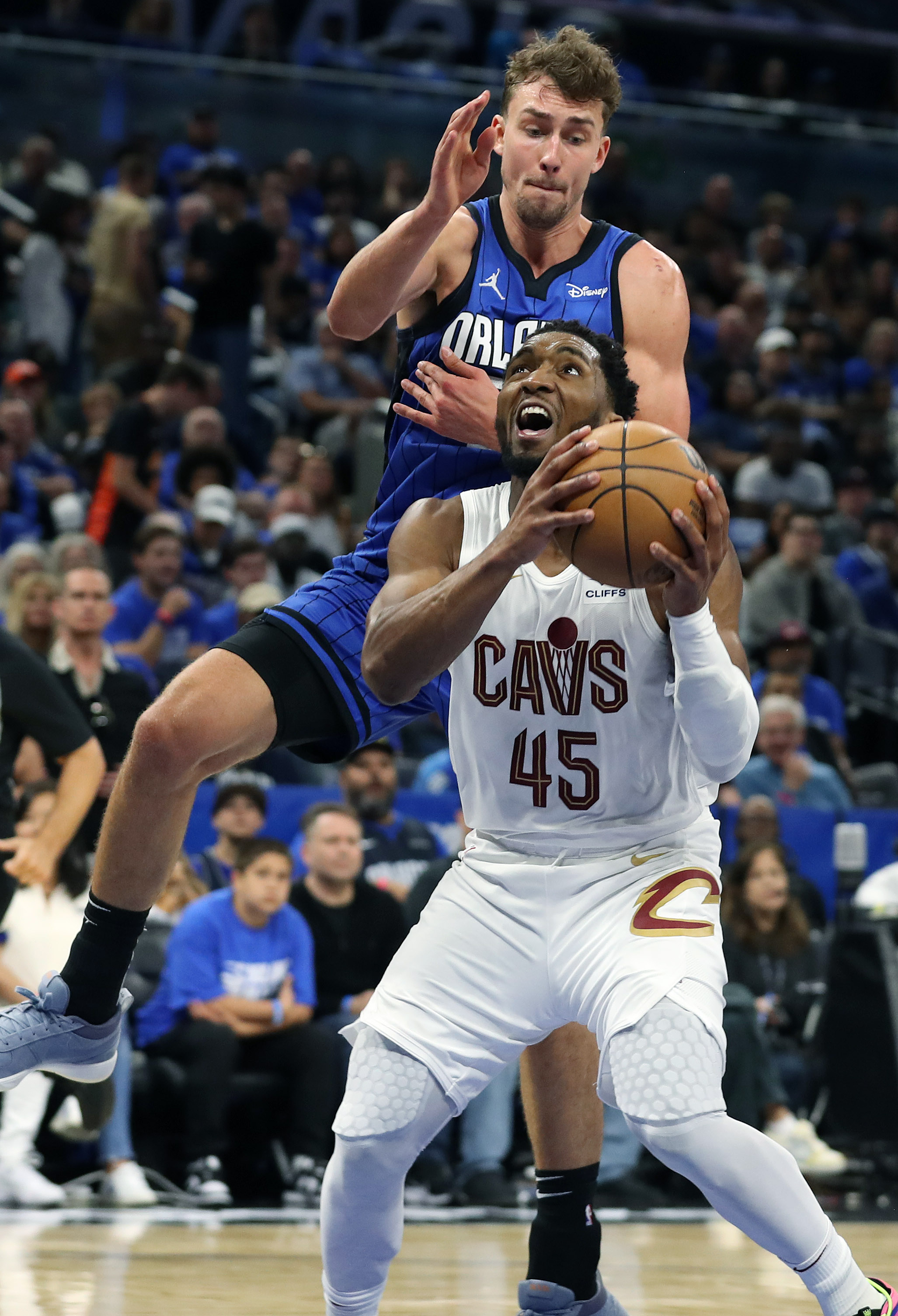 After leading the Cavs to a first-round victory against the Magic, Donovan Mitchell, drawing a challenge from Franz Wagner with a pump fake, received $150 million to stay in Cleveland. (Stephen M. Dowell/Orlando Sentinel)
