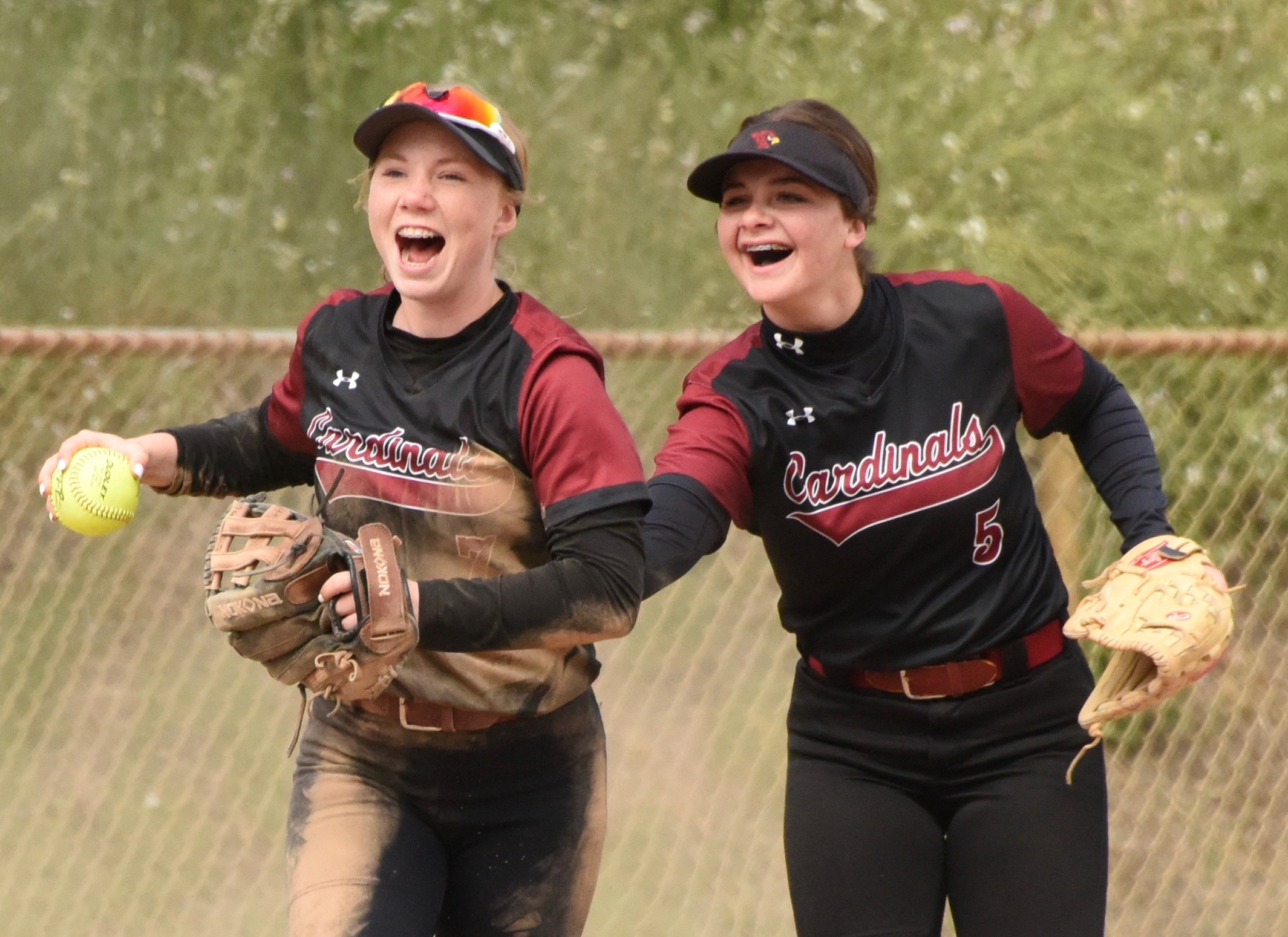 Flashing the leather in the top of the first inning against Hoopa was Clear Lake shortstop Amber Smart, who made a diving catch on a popup at the edge of the infeld behind third base. Congratulating Smart, with ball, is third baseman Camrin Pivniska. (Photo courtesy of Trett Bishop)