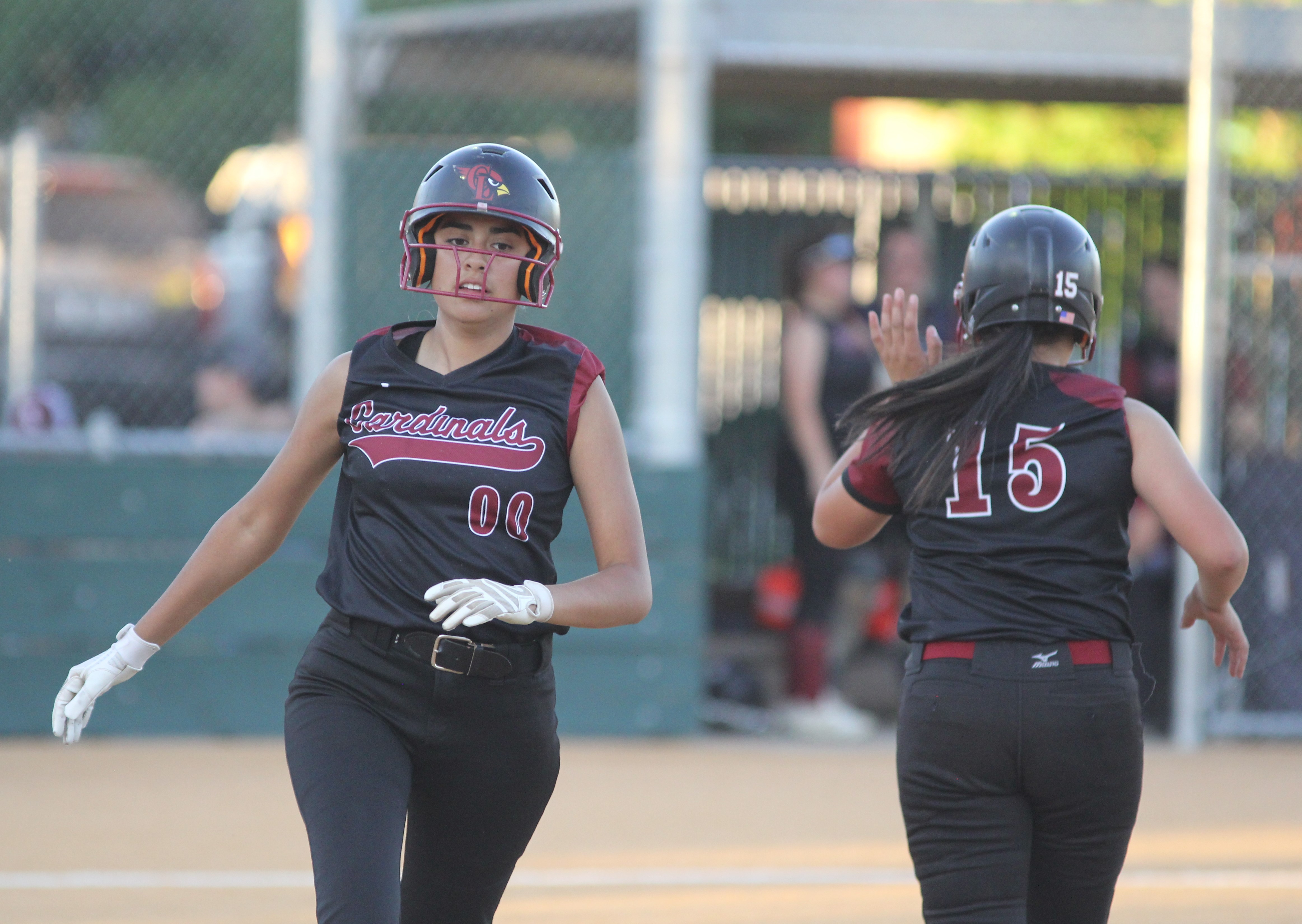 Courtesy runner Rubi Ford (left) replaces pitcher Lilianna Cruz in the top of the fourth inning. Cruz reached on an error, putting runners at the corners with two outs.