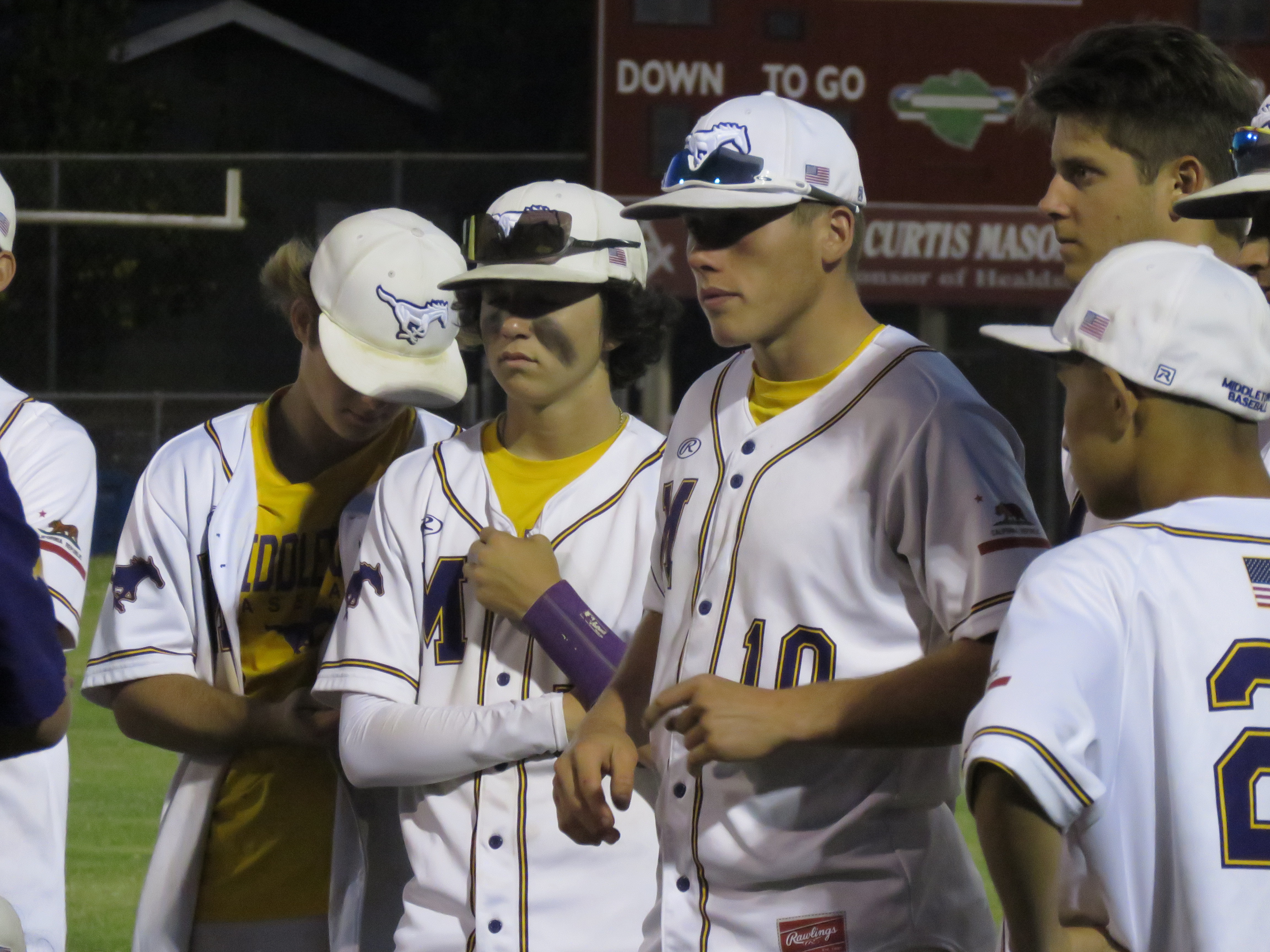 Middletown players look on during a postgame talk Wednesday night in Healdsburg where their season ended with a 3-1 first-round playoff loss to the Greyhounds.