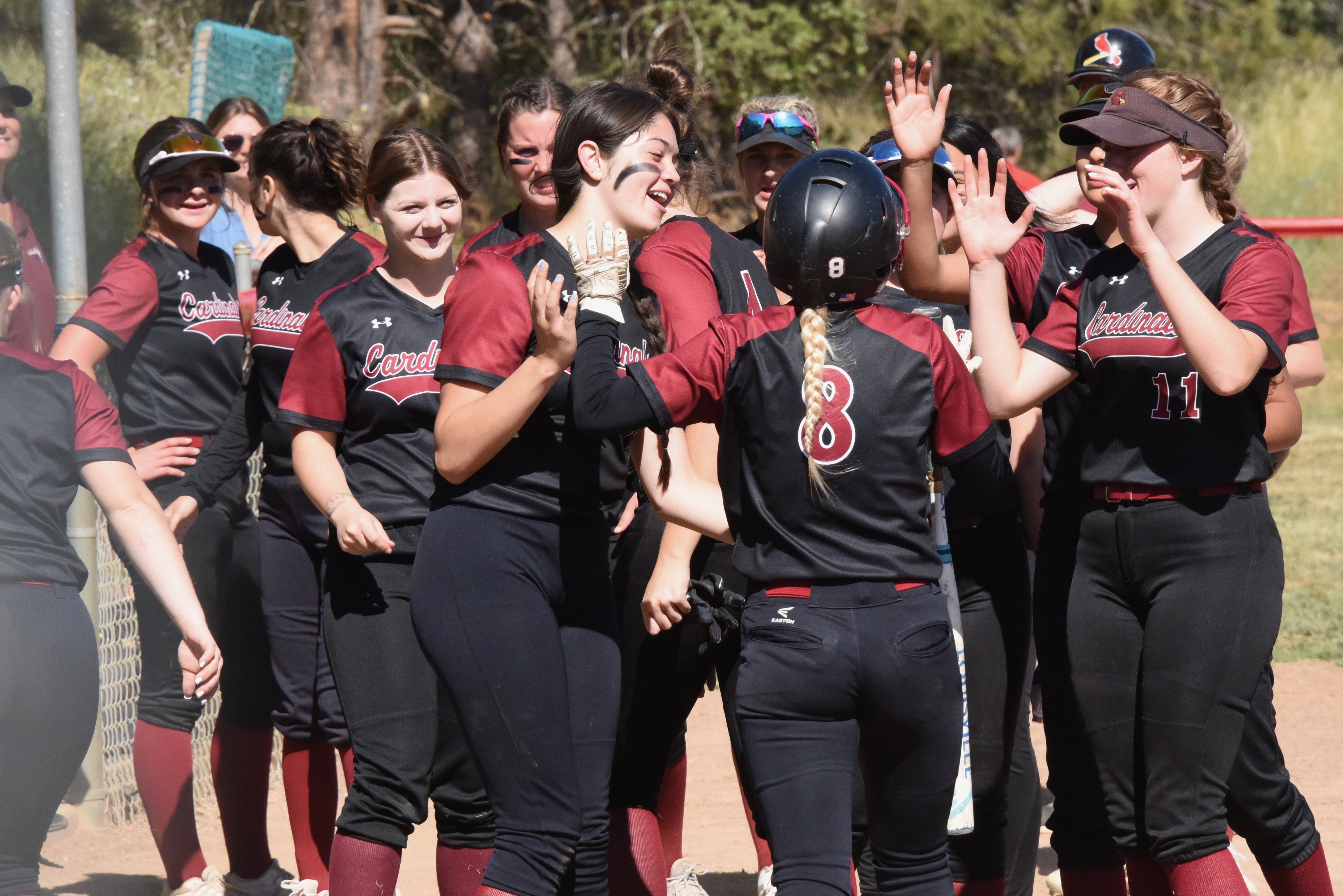 Clear Lake's Raina Clifton (8) is mobbed by teammates while returning to the dugout after her home run. The senior went 3-for-3 with three RBIs and also pitched all five innings for the victory. (Photos by Trett Bishop)