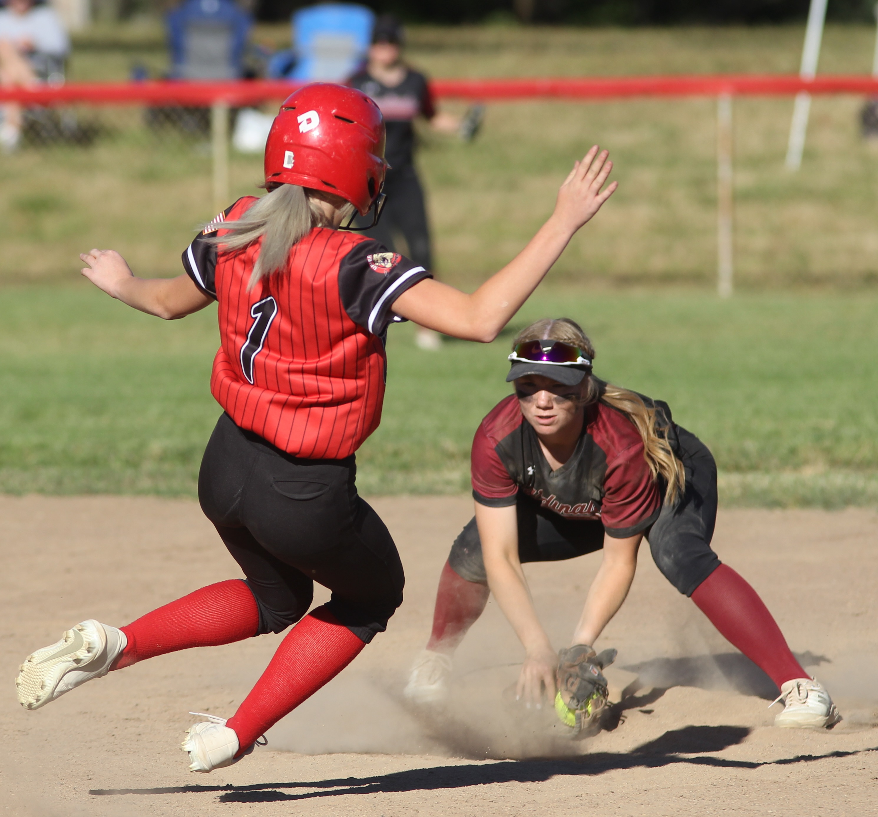 Shortstop Amber Smart waits at second, ball in glove, before tagging out would-be base stealer Ashley Rhodes to end the top of the fifth inning.