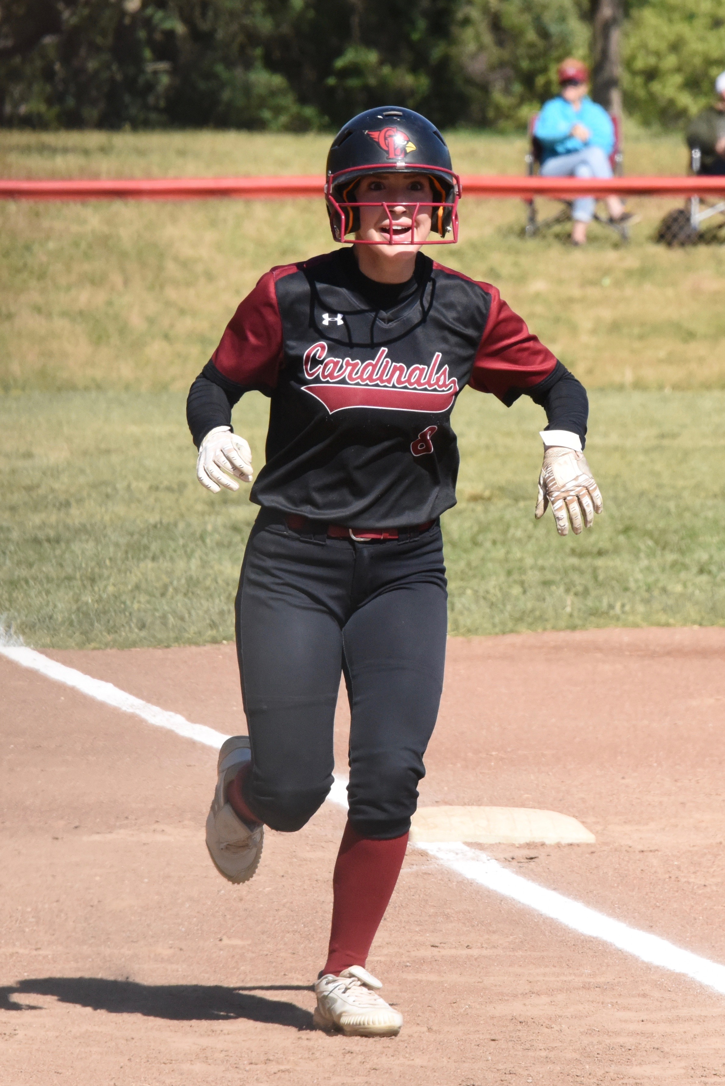 Raina Clifton is all smiles as she approaches home plate after homering in the bottom of the first inning.