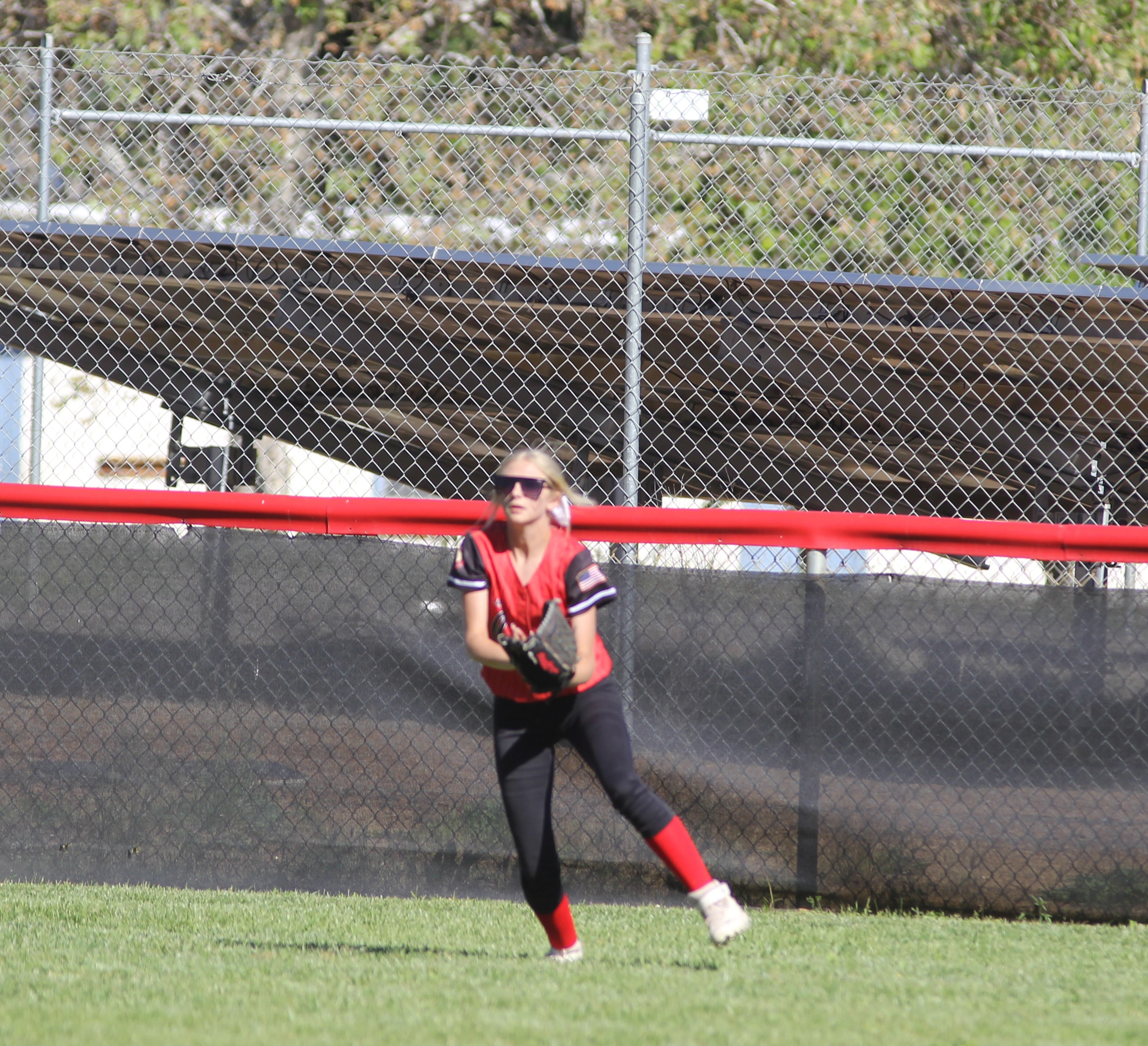 Upper Lake center field Tristin Rhodes gloves a deep flyball off the bat of Clear Lake's Raina Clifton in the bottom of the third.