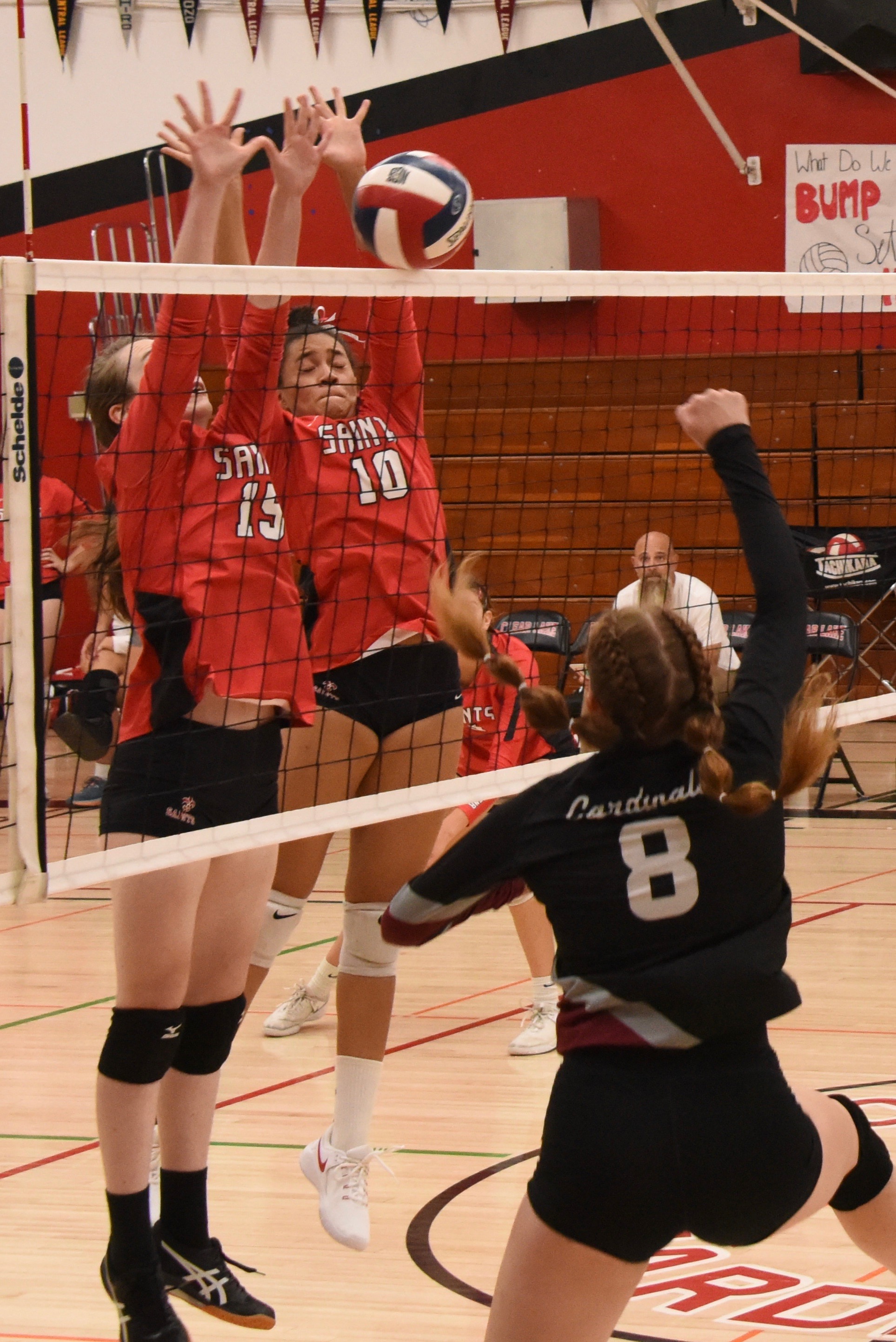 Clear Lake's Stella Hill blasts a shot over the net as a pair of St. Helena defenders try for the block. (Photos courtesy of Trett Bishop)