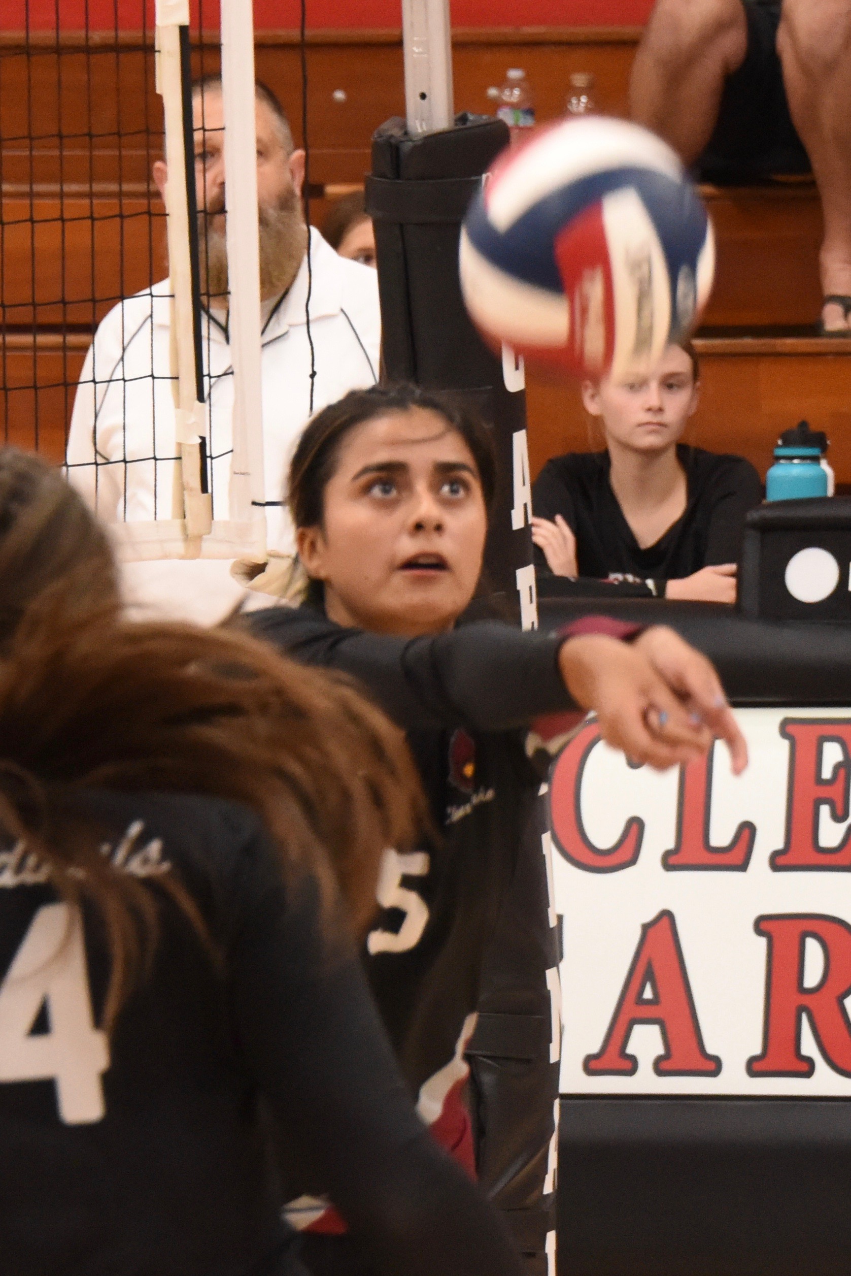 Clear Lake's Rubi Ford keeps her eye on the ball as Montana Wells (4) looks on.