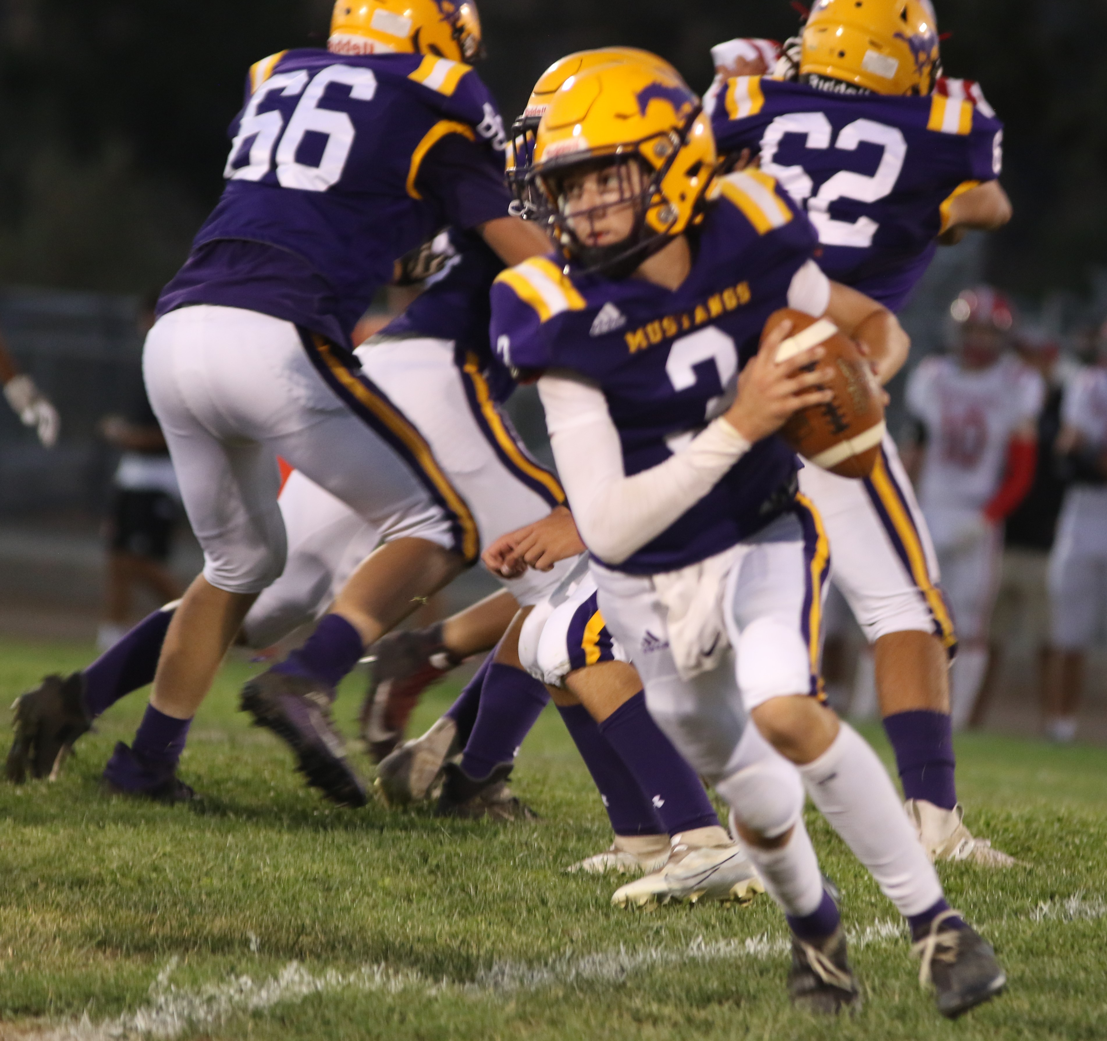 Middletown quarterback Hunter Hartzog scrambles to the outside in the fourth quarter. Hartzog went 7-for-15 passing for 94 yards in his varsity debut. (Photos by Minenna Photography)