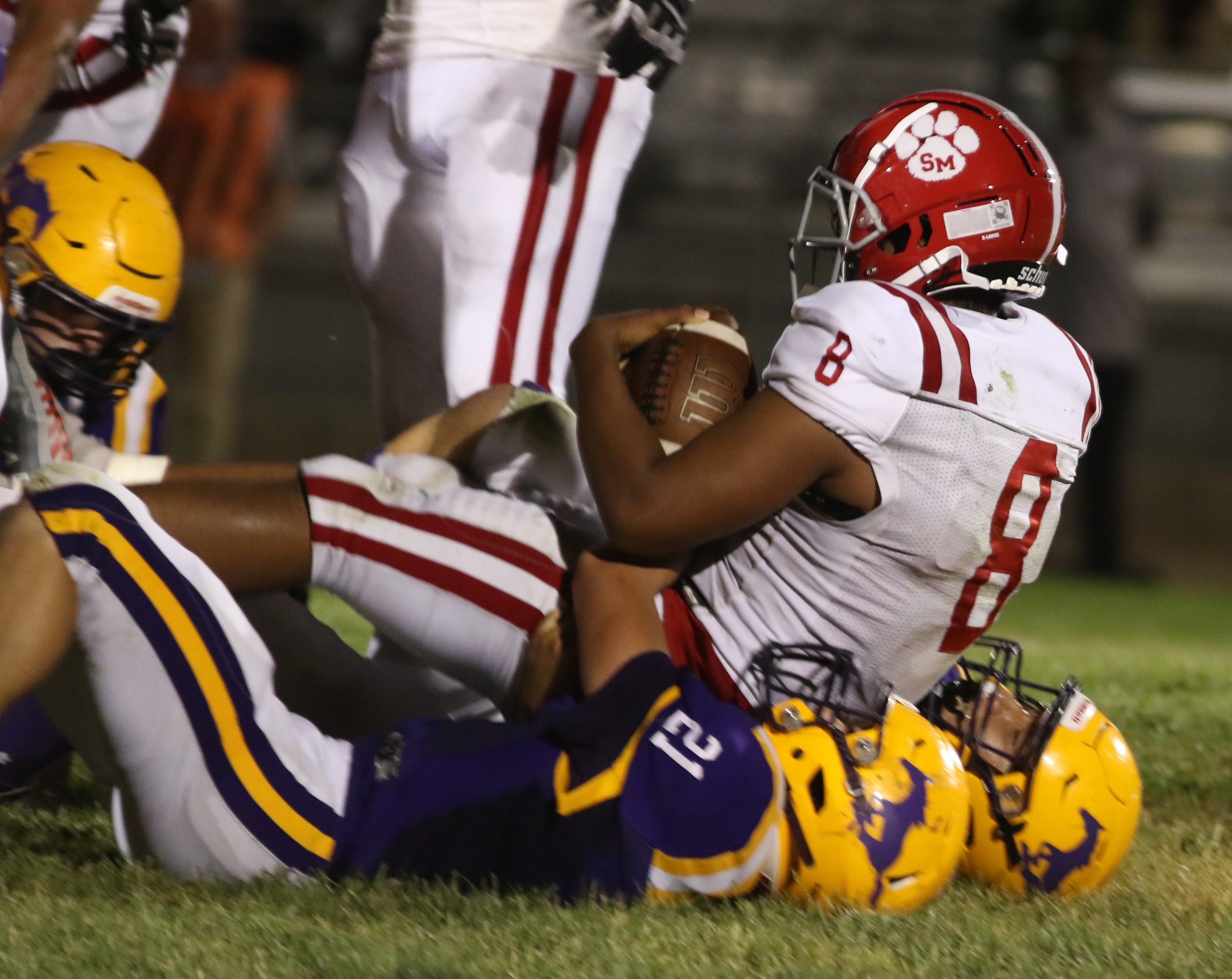 St. Mary's fullback Kyle Goree lands on top of Middletown's Jacob Urbina (21) and a teammate during Friday's action. Goree rushed for 59 yards, including a 25-yard touchdown in the second quarter that was the difference in the Panthers' 7-0 win over Middletown. (Photos by Minenna Photography)
