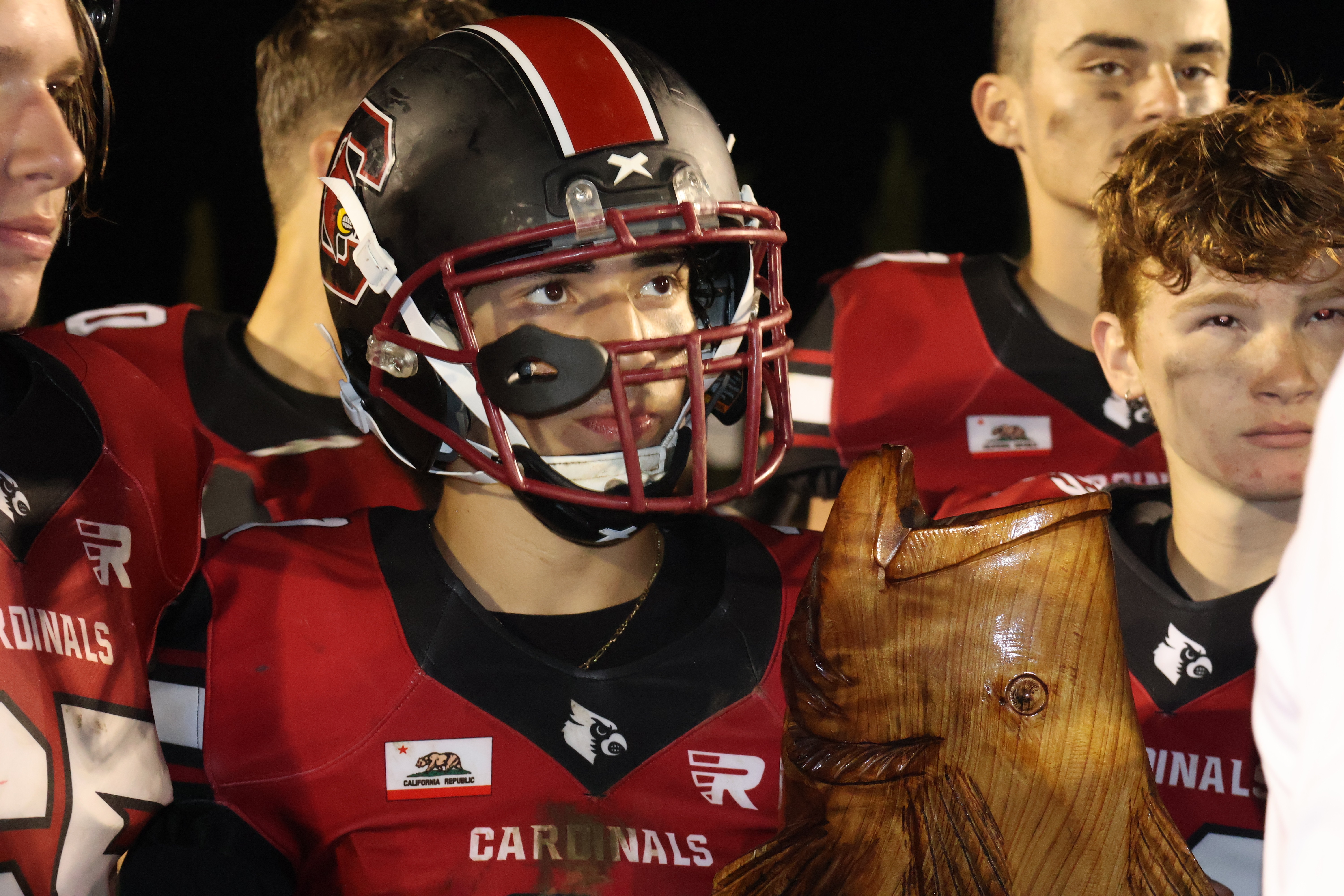 Clear Lake's Saul Reyes clutches the Bass Bowl trophy following the Cardinals' 43-33 win over Kelseyville. (Photos by Brian Sumpter)