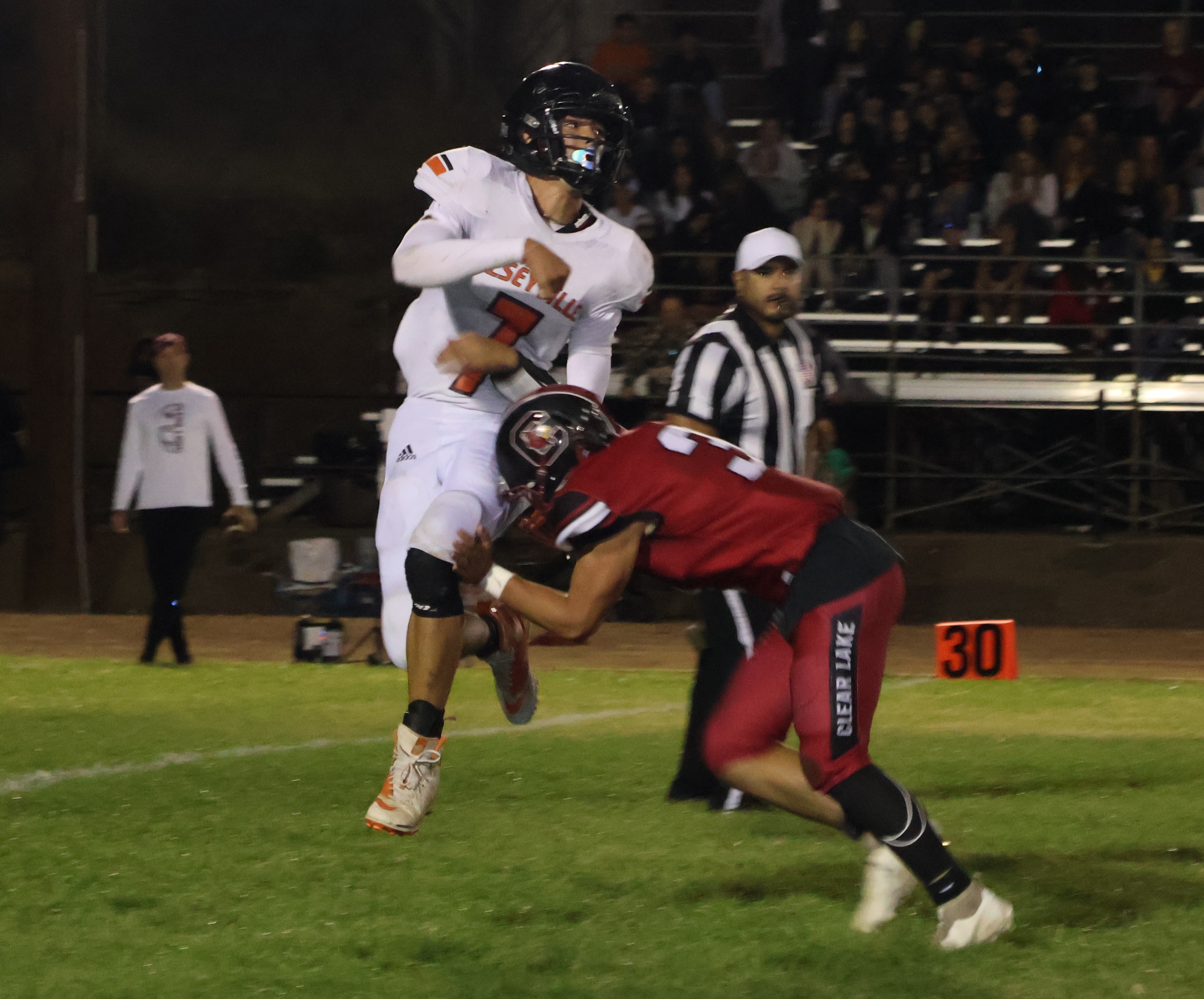 Kelseyville quarterback Luke Watkins follows the flight of his pass as Clear Lake's Hank Ollenberger applies some pressure. Watkins passed for two touchdowns and ran for two others in a 43-33 loss to Clear Lake. (Photos by Brian Sumpter)