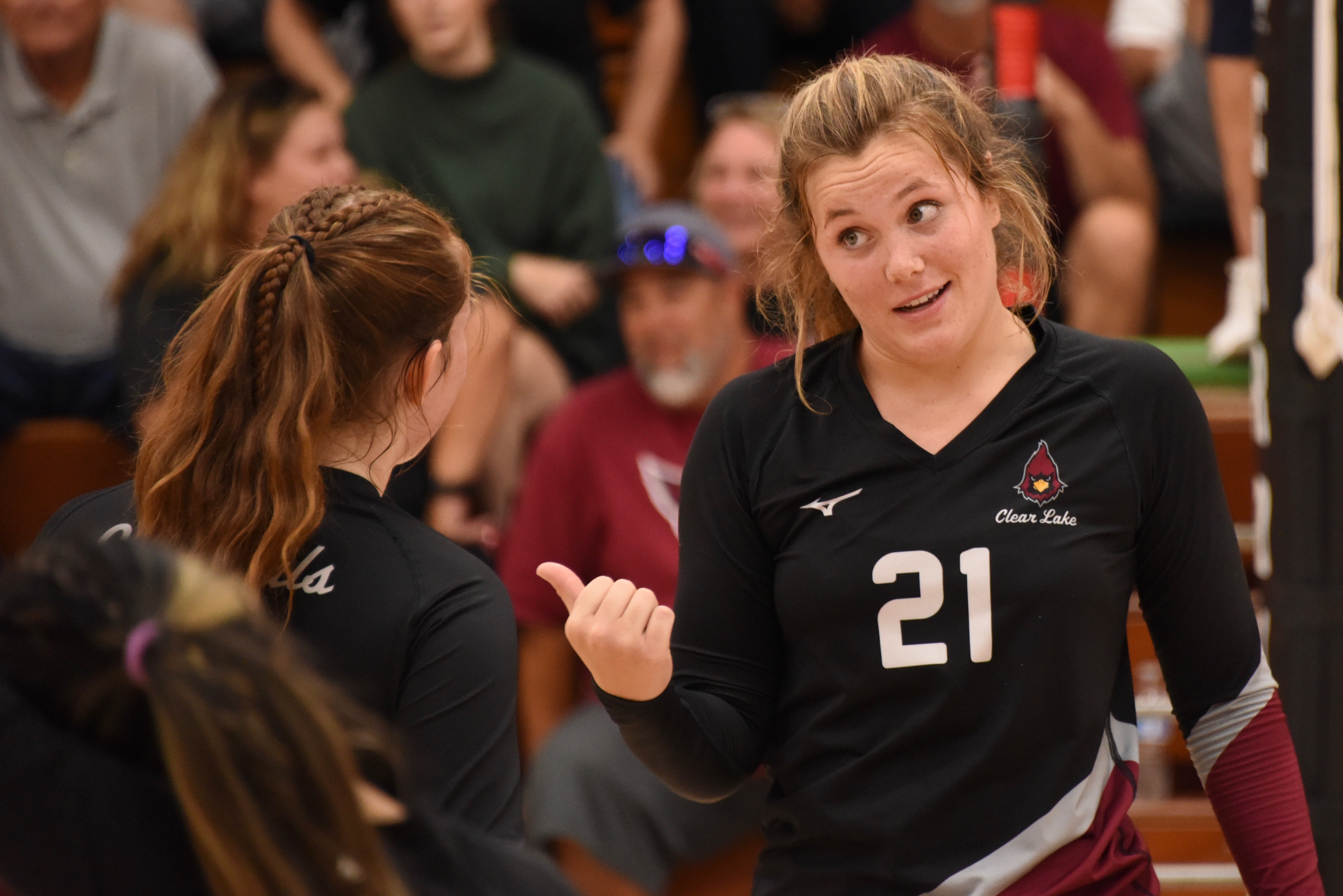 Clear Lake's Abby Mertle (21) discusses the situation with Stella Hill during a 25-22 win in the first set against Roseland University Prep on Thursday night in Lakeport. RUP rallied to win the league match in four sets. (Photo courtesy of Trett Bishop)