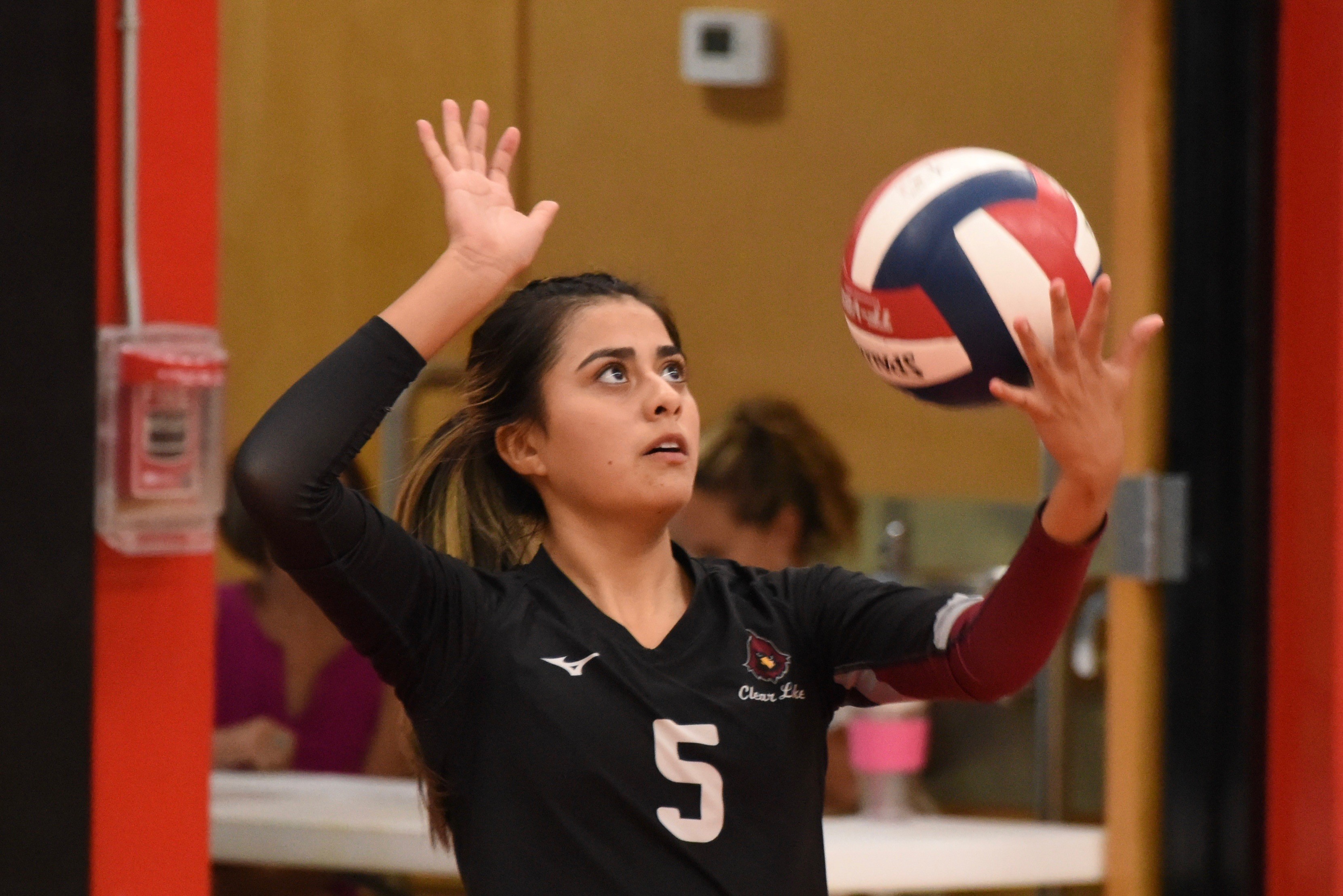 Rubi Ford readies a serve for Clear Lake. Ford was one of the Cardinals' top performers Thursday night against defending league champion Roseland University Prep. (Photos by Trett Bishop)