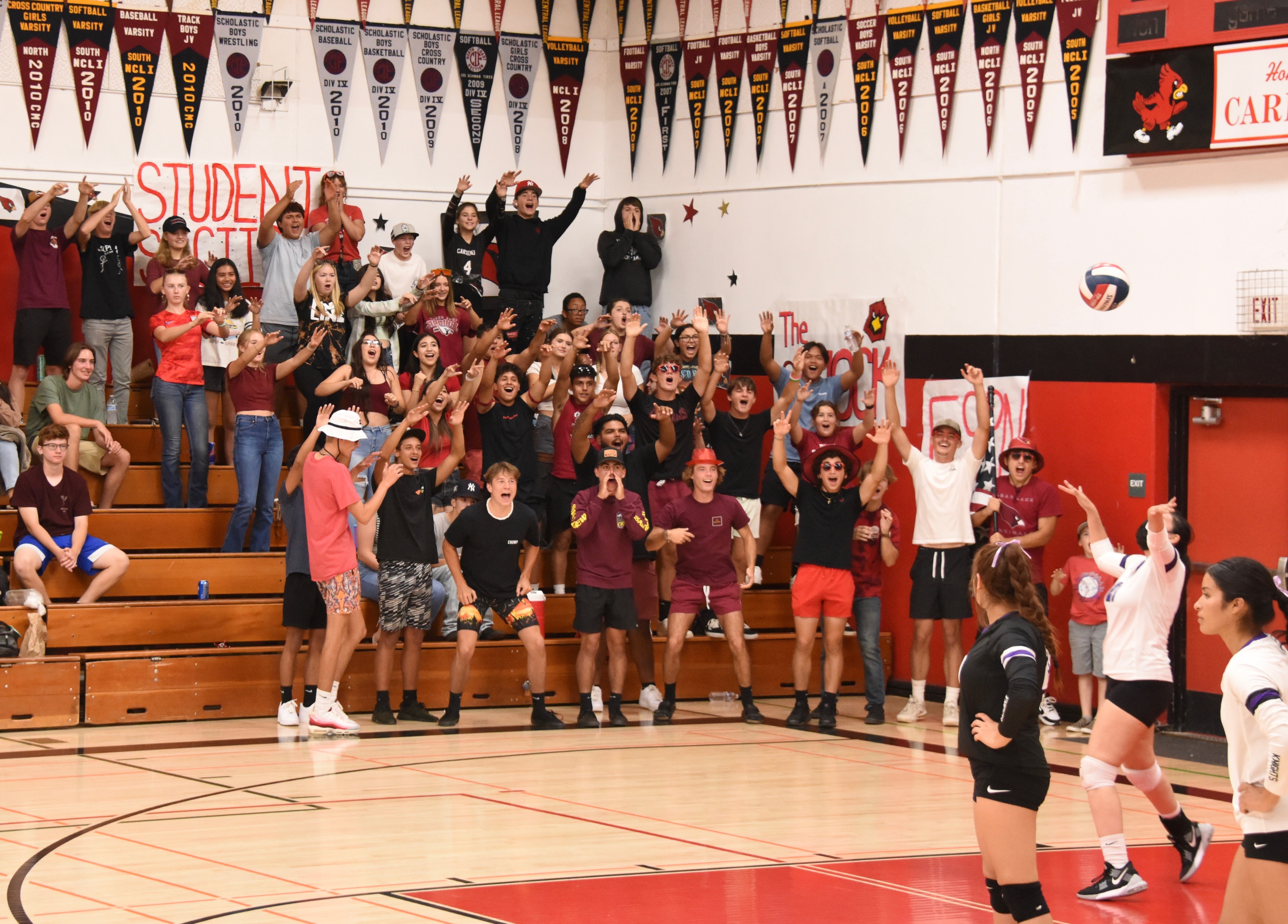 Clear Lake's student rooting section lets the Roseland University players hear about it early on in Thursday's match. The visiting Knights had the last laugh with a four-set victory over the Cardinals. (Photos courtesy of Trett Bishop)