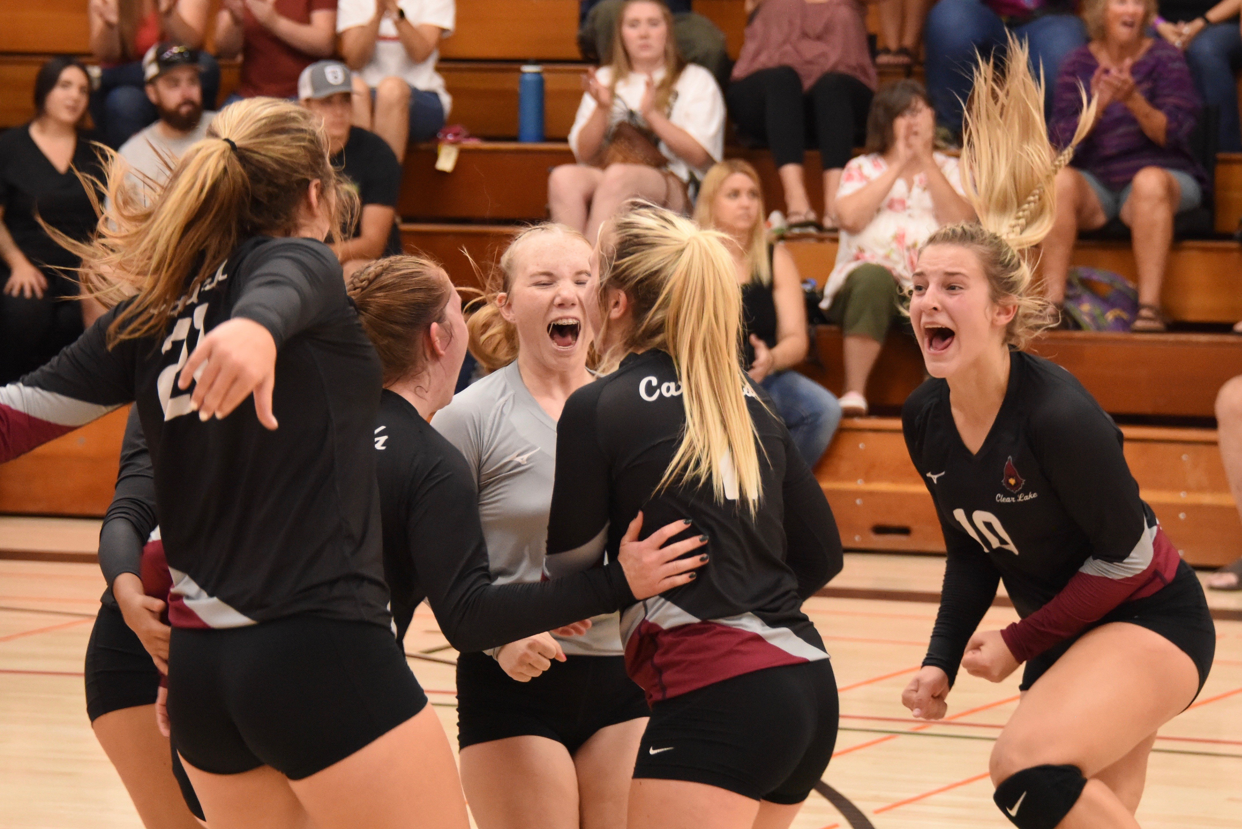 Libero Amber Smart (facing camera) and Quincy Paarsch (10) celebrate with teammates after winning a big point in the first set. (Photos courtesy of Trett Bishop)