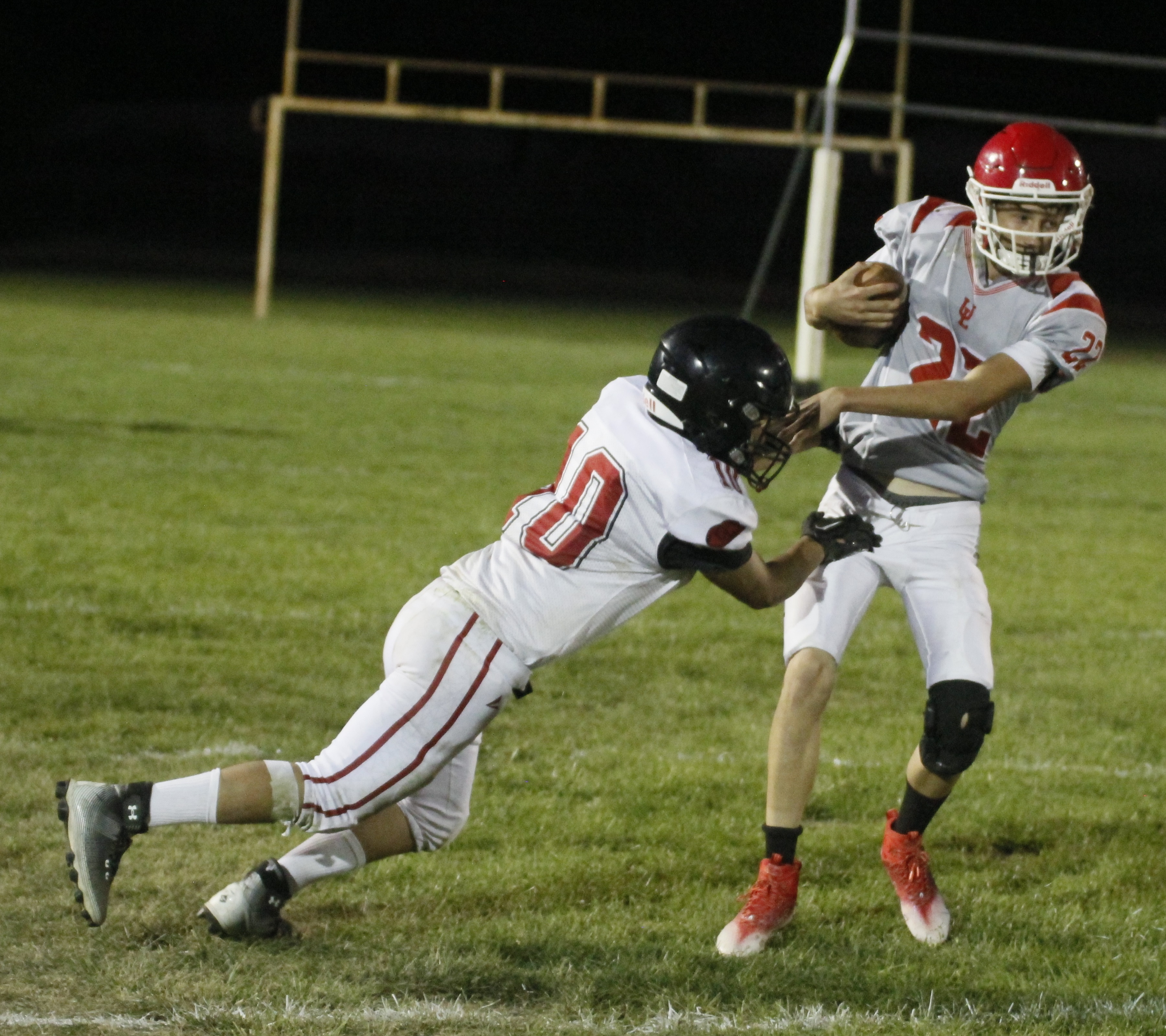 Upper Lake quarterback Jerod Rosales shakes off a Tomales defender to keep the play alive Friday night in Upper Lake. (Photos by Minenna Photography)
