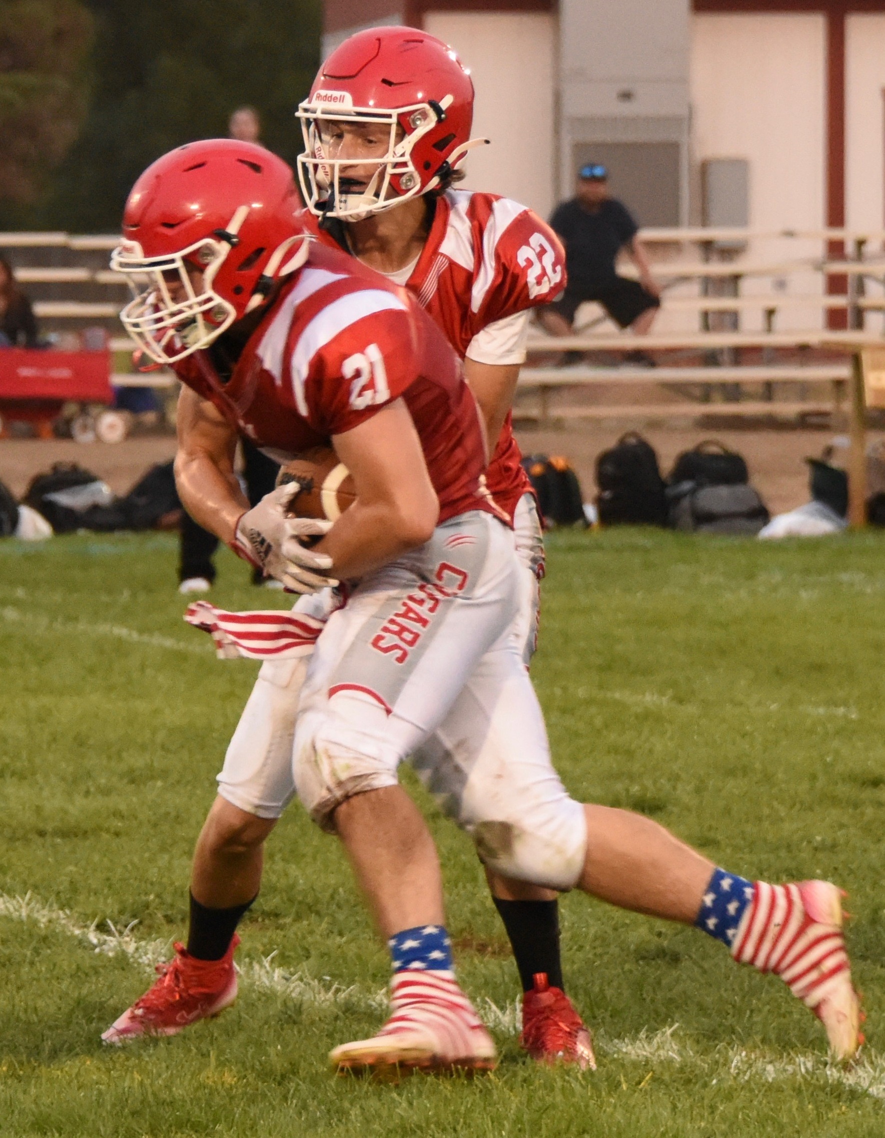 Upper Lake quarterback Jerod Rosales hands the ball off to running back Will Henry, who had two rushing scores and three touchdowns overall in a 52-18 win over Roseland University Prep. (Photos courtesy of Trett Bishop)