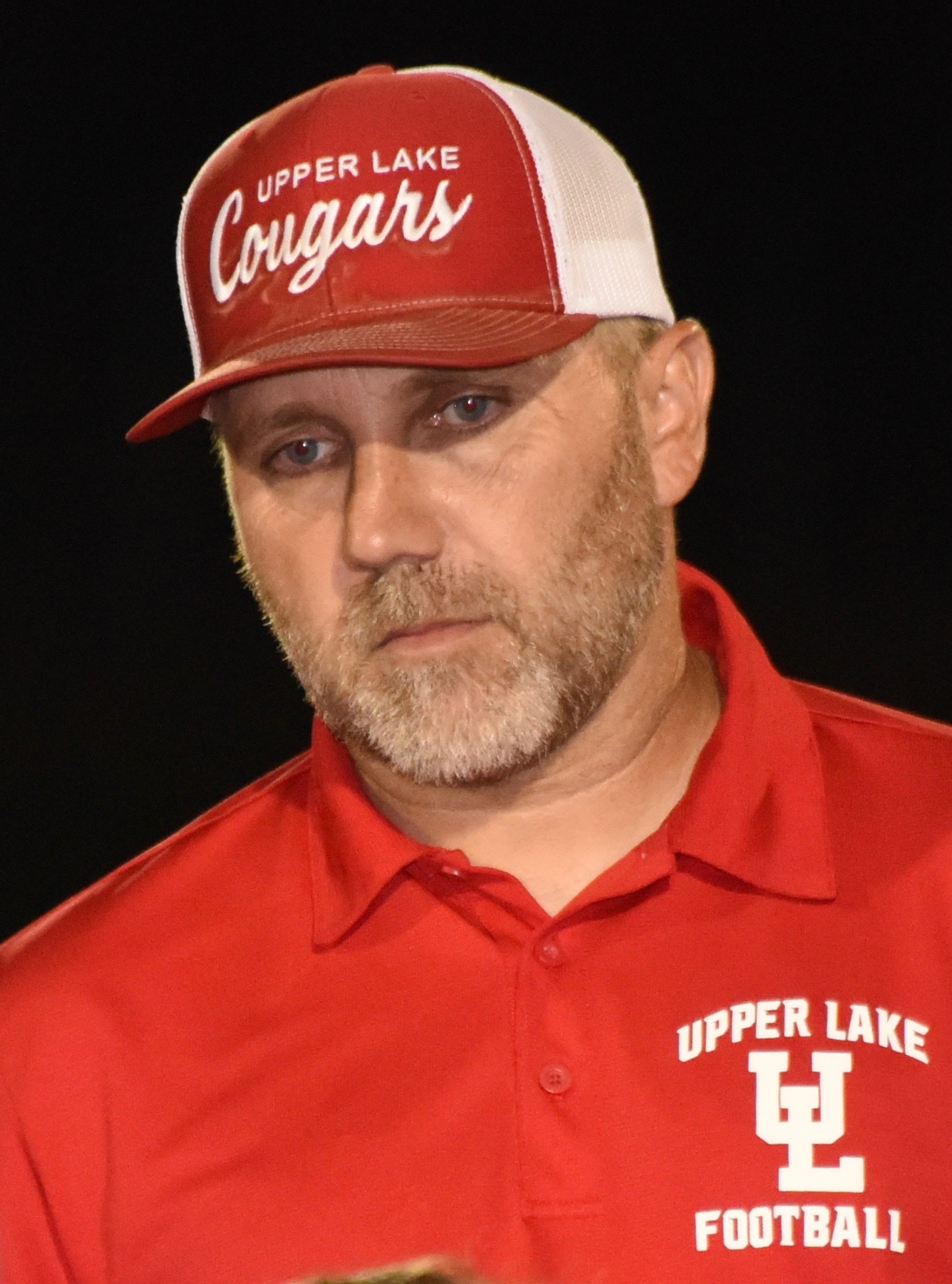 Upper Lake head coach Vince Moran looks on during a postgame meeting with players. (Photos courtesy of Trett Bishop)