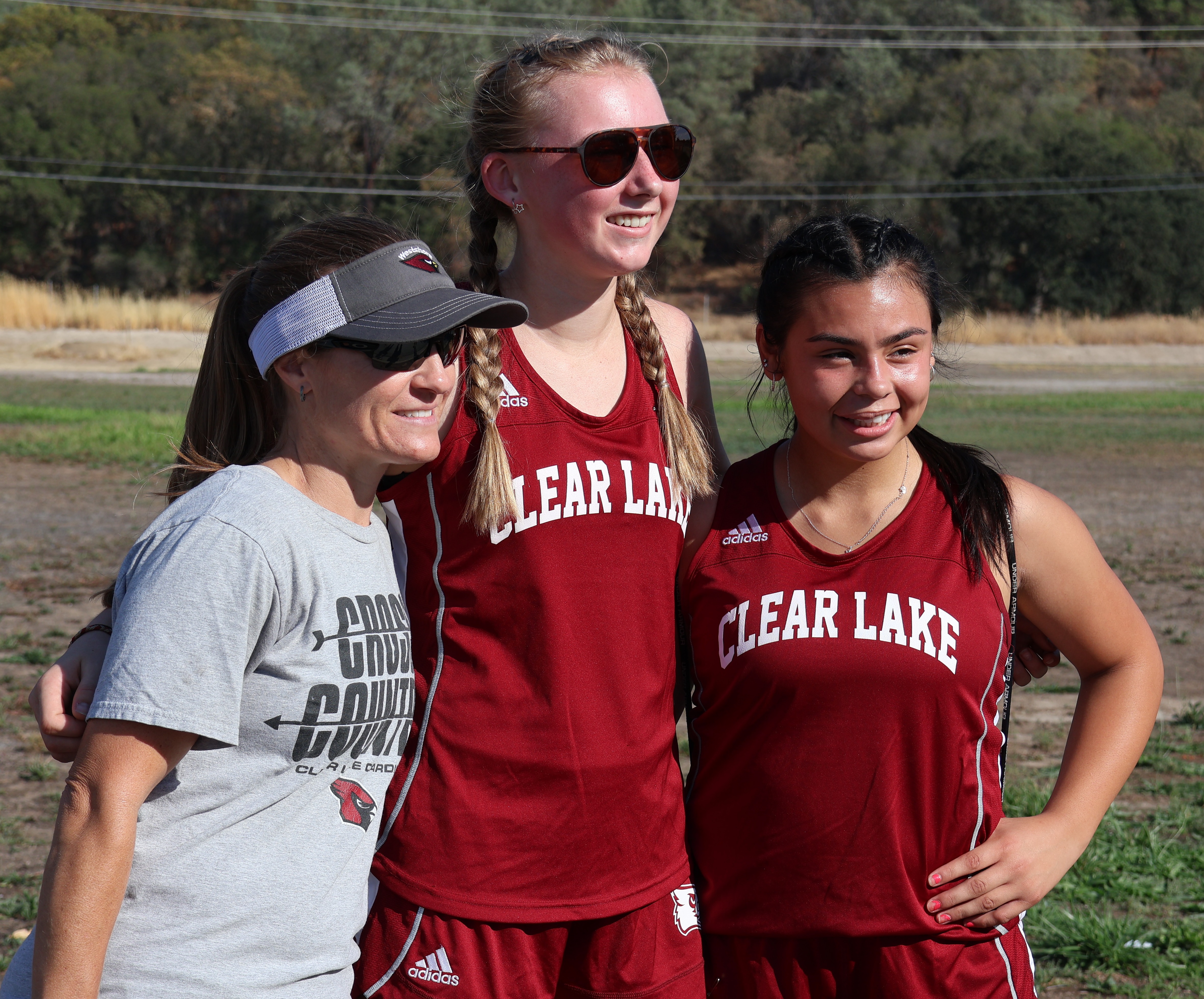 Clear Lake High School cross country Tammy Lisk poses with Hannah Garrity and Lilianna Cruz following the Cardinals' season opener Wednesday in Kelseyville. (Photos by Brian Sumpter)