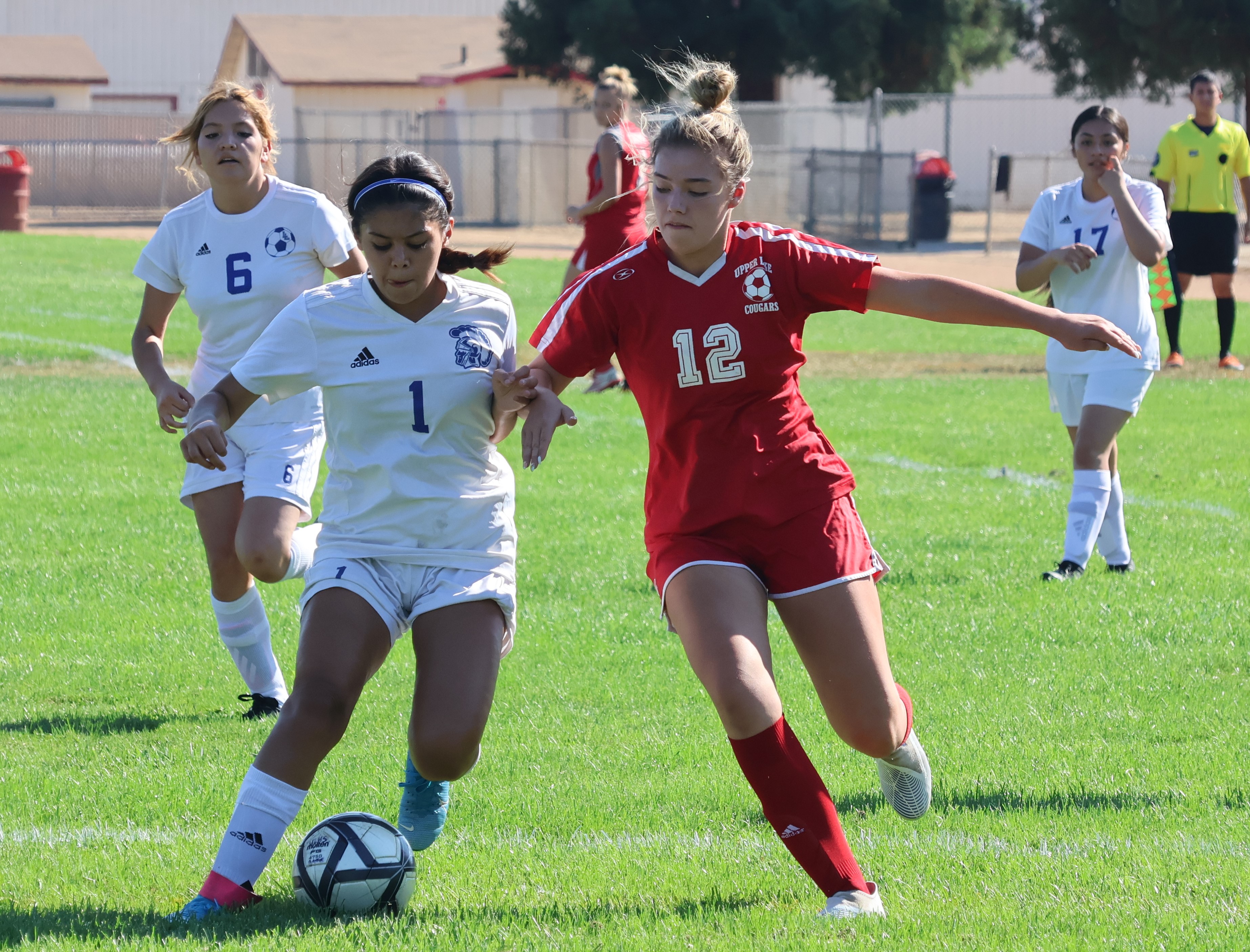Lower Lake defender Hanahi Boracio (left) tries to keep the ball away from Upper Lake's Nya Marcks during action in the first half Thursday afternoon in Upper Lake. Looking on are Boracio's teammates, Maria Perez Tapia (6) and Esmeralda Lopez (17). (Photos by Brian Sumpter)