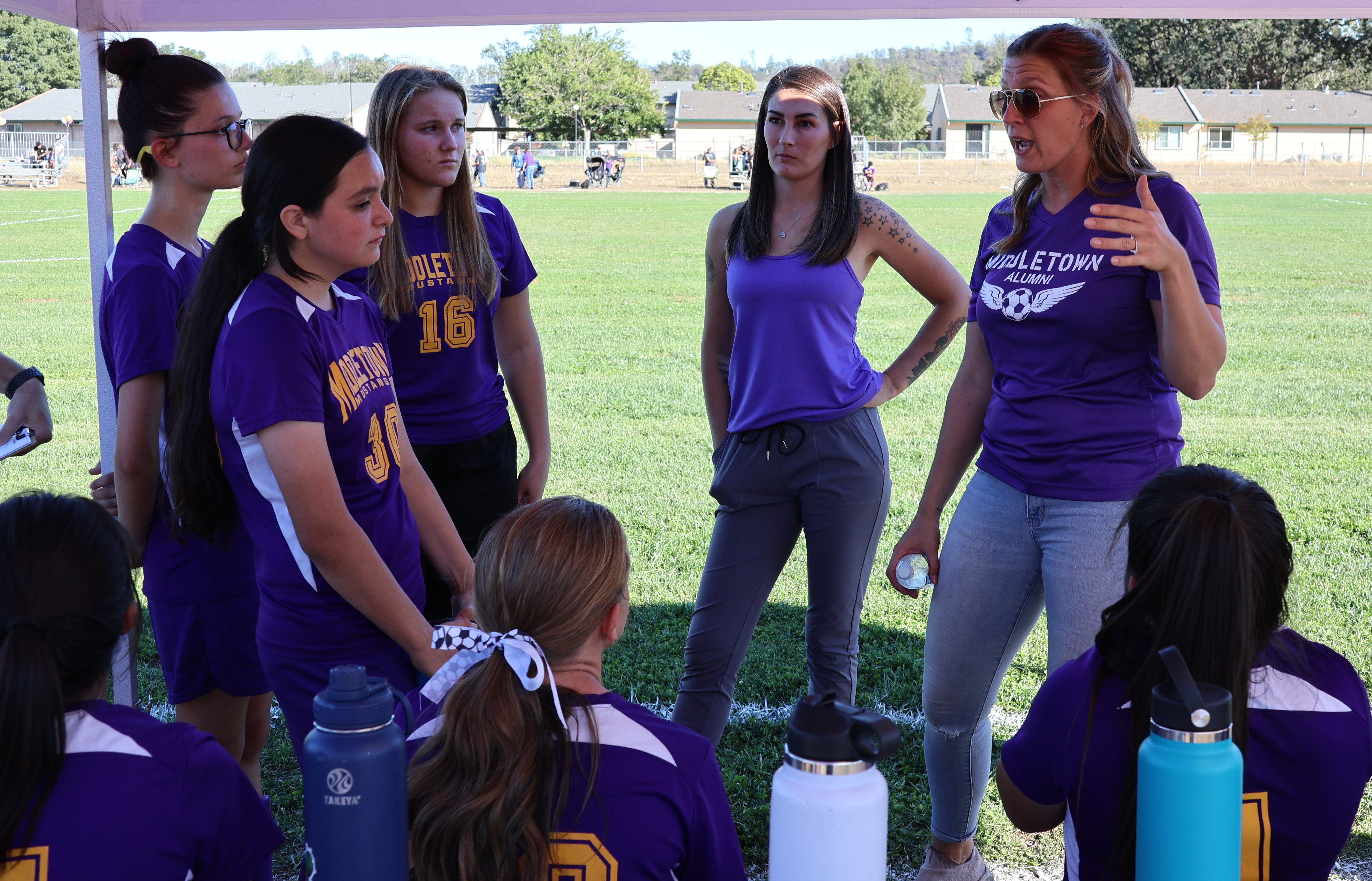 Middletown's new girls soccer head coach, alum Ashlyn Welton, talks to her team during halftime. (Photos by Brian Sumpter)