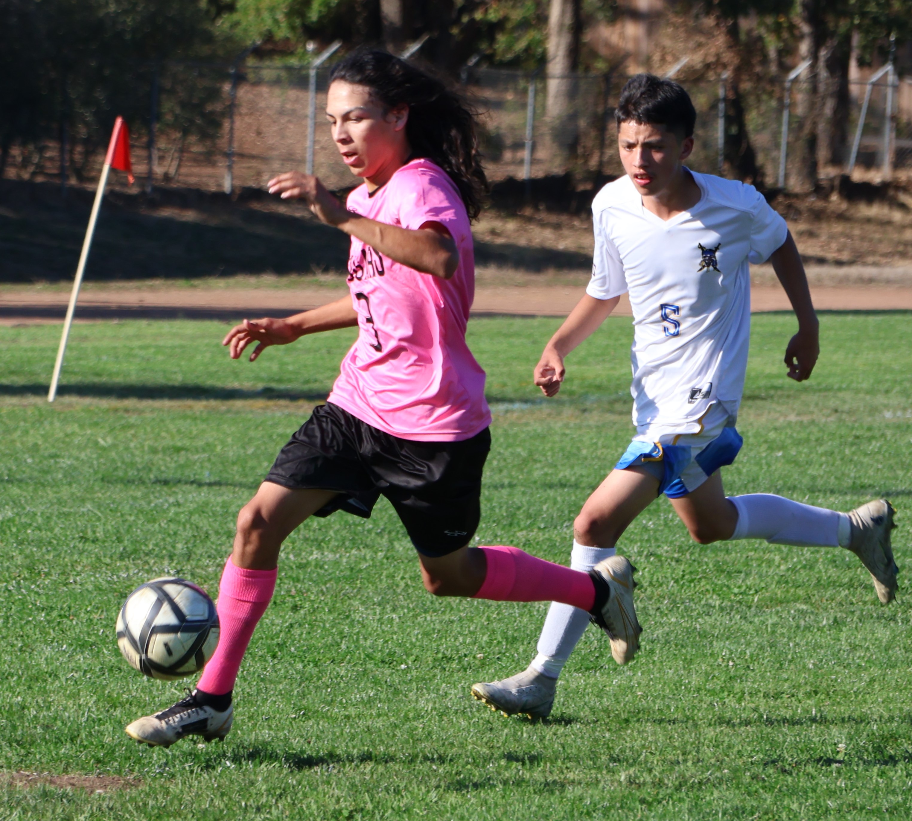 Upper Lake's Sammy Avalos goes on the attack as Point Arena's Jael Orsini trails the play. (Photos by Brian Sumpter)