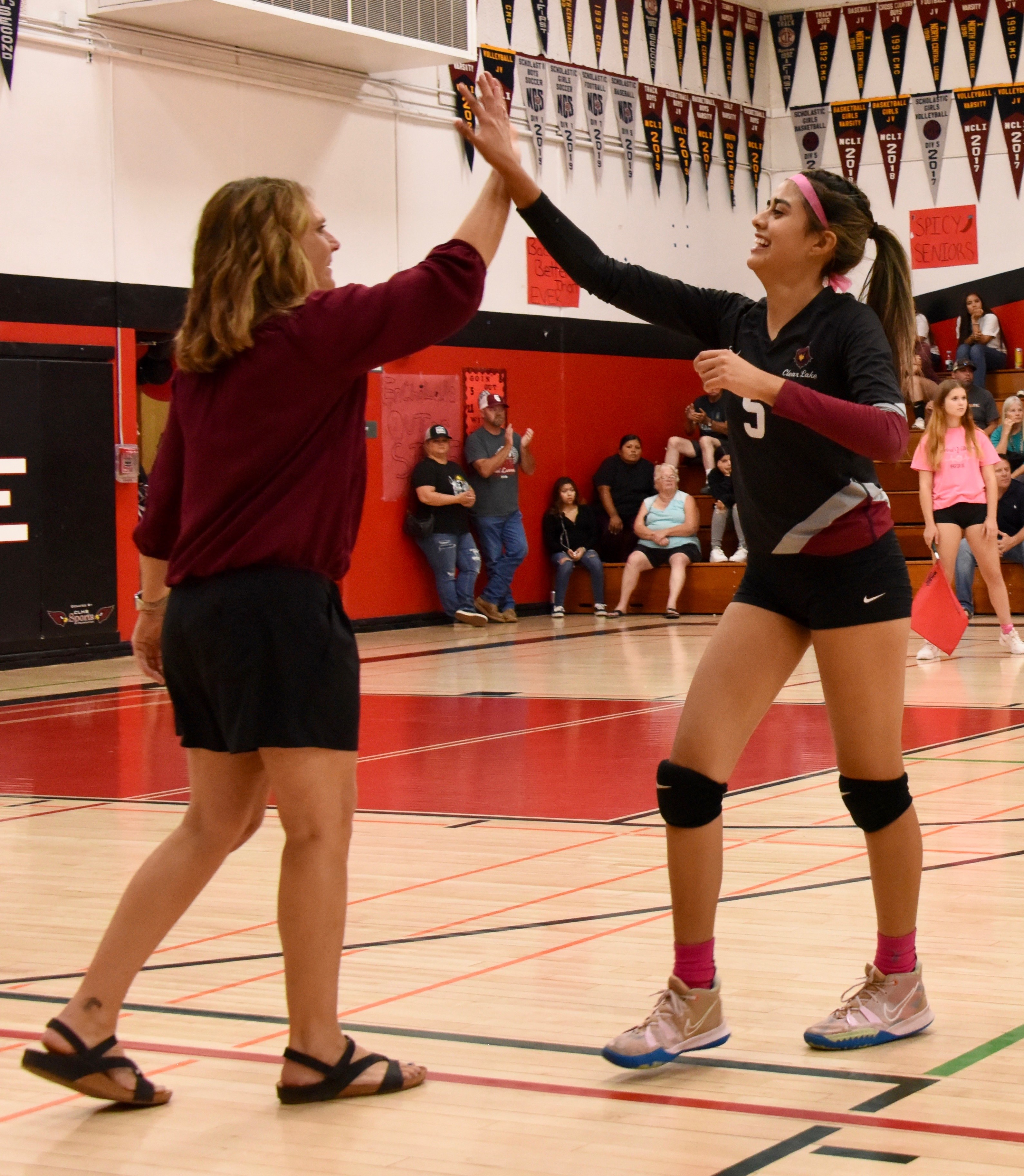 Clear Lake head coach Marci Psalmonds exchanges high-fives with senior Rubi Ford as she exits the court Thursday night. (Photos courtesy of Trett Bishop)