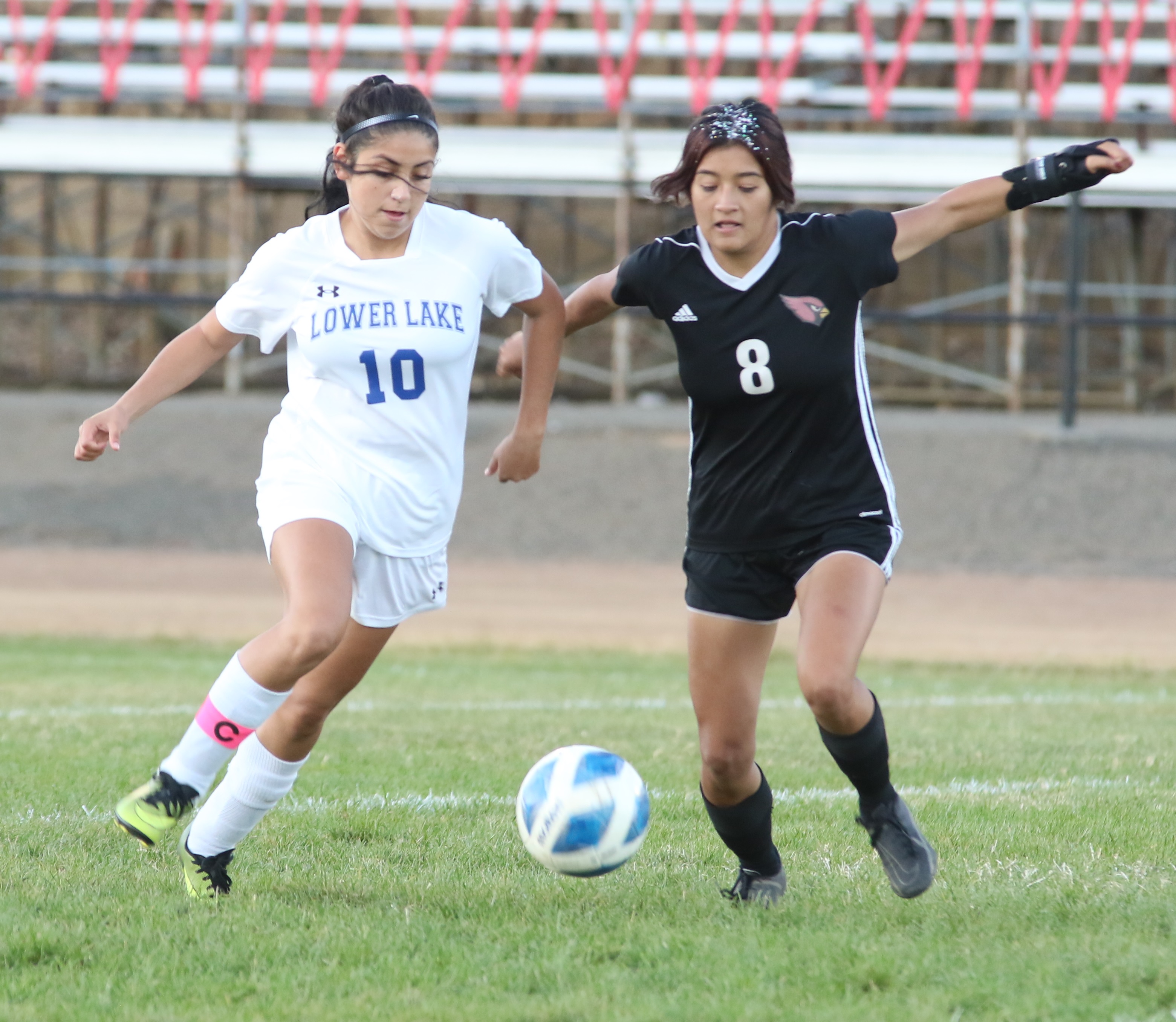 Lower Lake's Yamilet Saucedo (left) is defended by Clear Lake's Anyssa Perez in the first half. (Photos by Minenna Photographry)