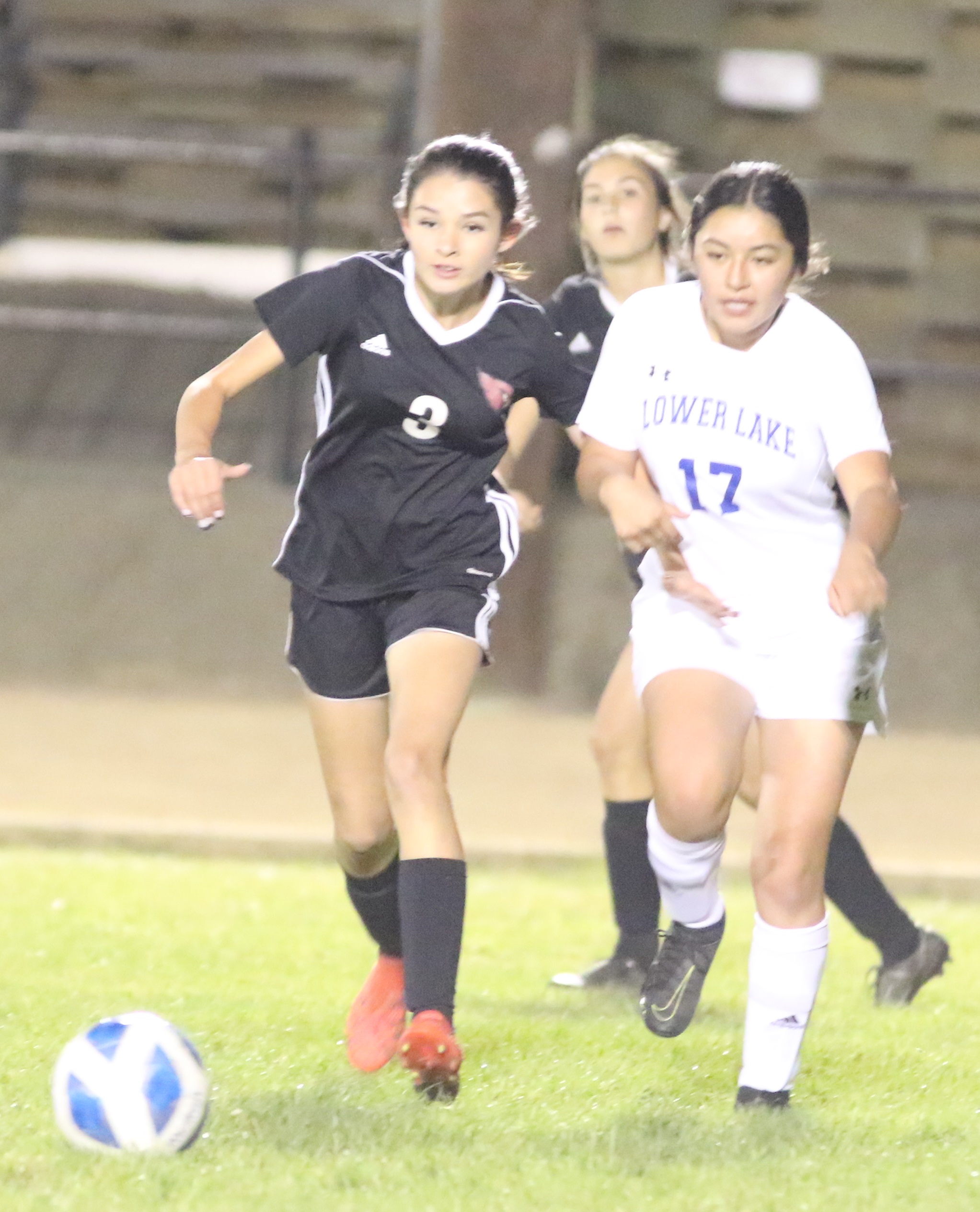 Clear Lake's Giselle Carbajal (left) and Lower Lake's Esmeralda Lopez pursue a free ball. (Photos by Minenna Photography)