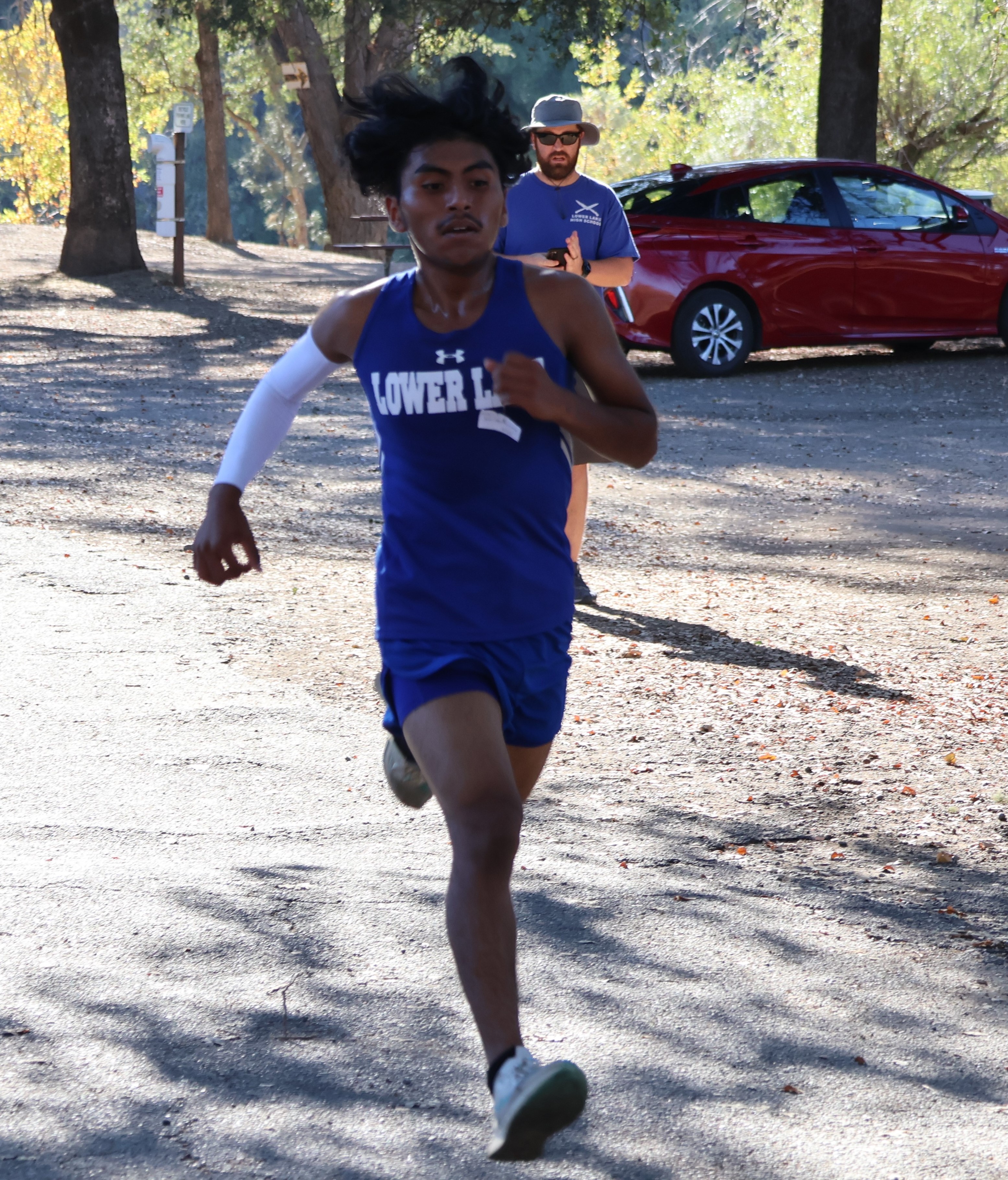 Lower Lake's Jose Hernandez sprints to the finish line Wednesday while winning the varsity boys race at the 3.28-mile Highland Springs course just south of Lakeport. Hernandez has won each of his last three races. (Photos by Brian Sumpter)