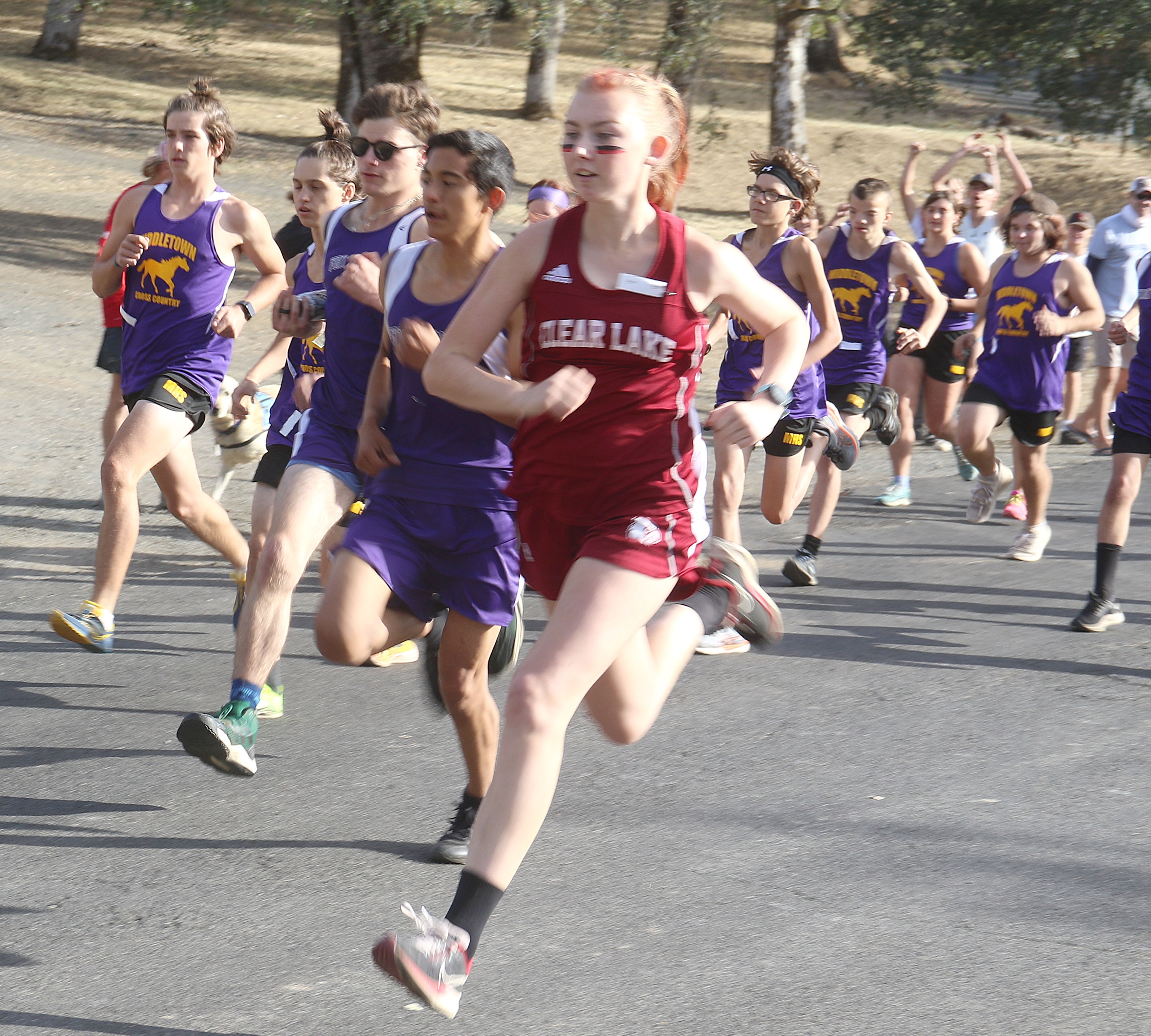 Clear Lake's Hannah Garrity breaks from the starting line along with a host of Middletown and Fort Bragg runners Wednesday afternoon during a North Central League I tri-meet at Highland Springs. Garrity won the girls race in 21 minutes, 1 second and was rooted on by members of the school's football team. (Photos by Minenna Photography)