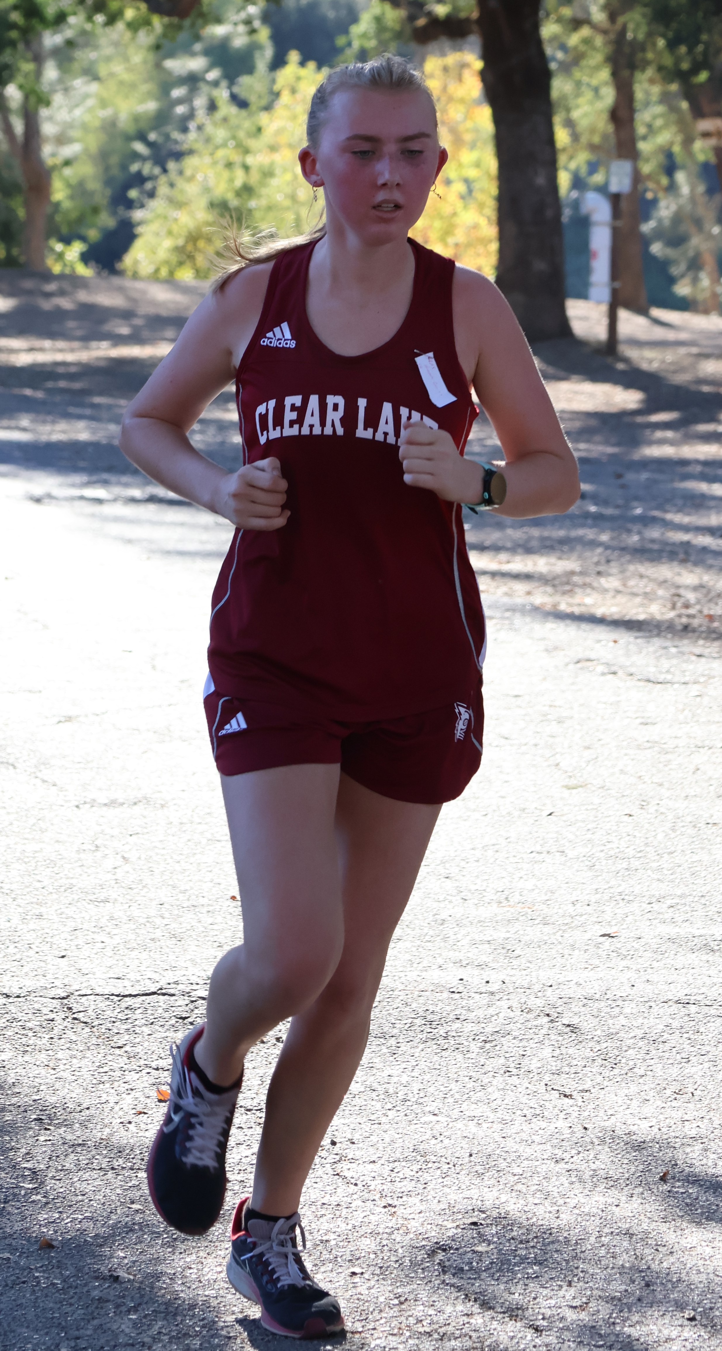 Clear Lake's Hannah Garrity crosses the finish line first in the girls race. (Photos by Brian Sumpter)