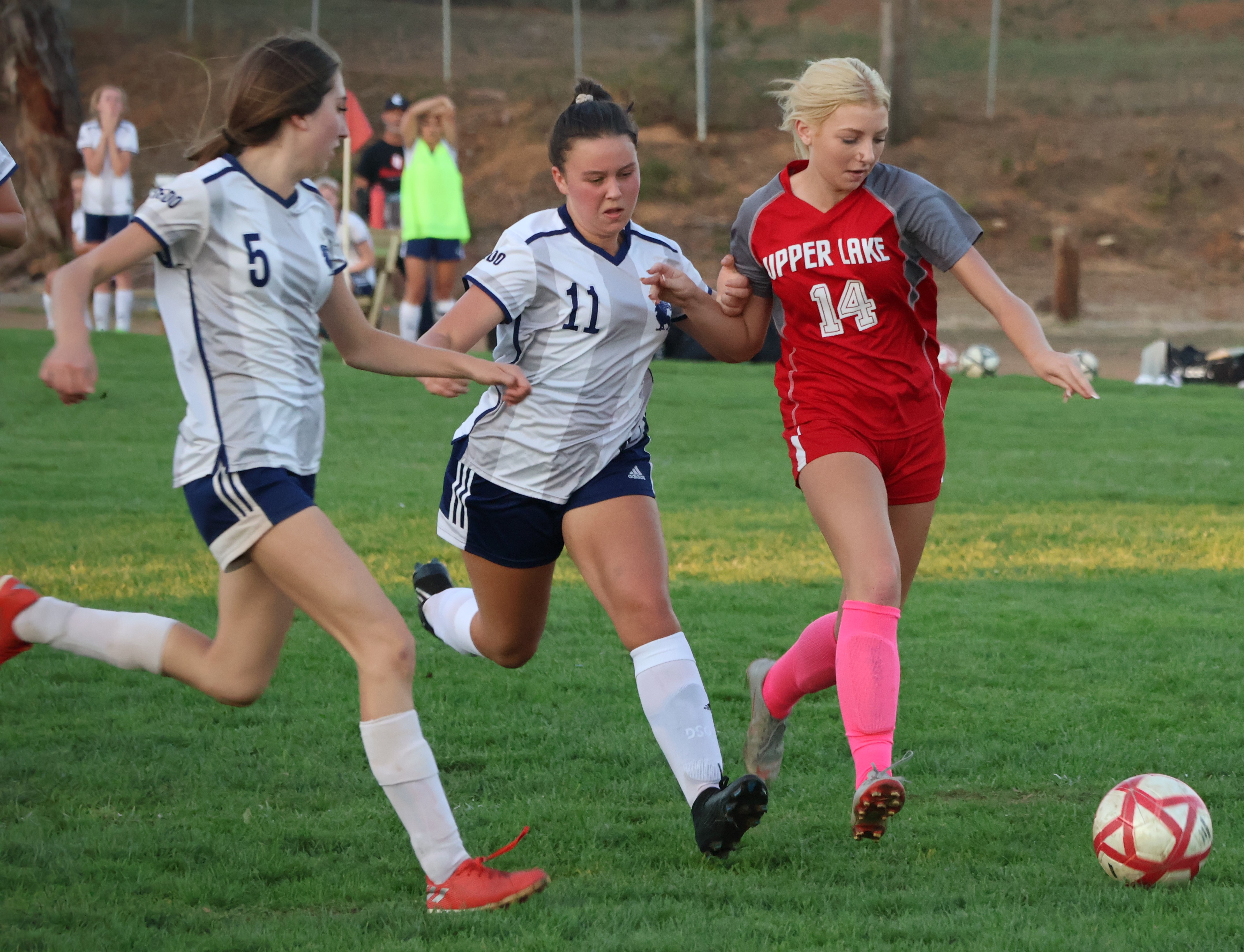 Upper Lake's Ashlyn Rhodes sets up for a shot on goal while being pursued by Credo's Maria Kaufman (5) and Roma Duffy (11). (Photos by Brian Sumpter)