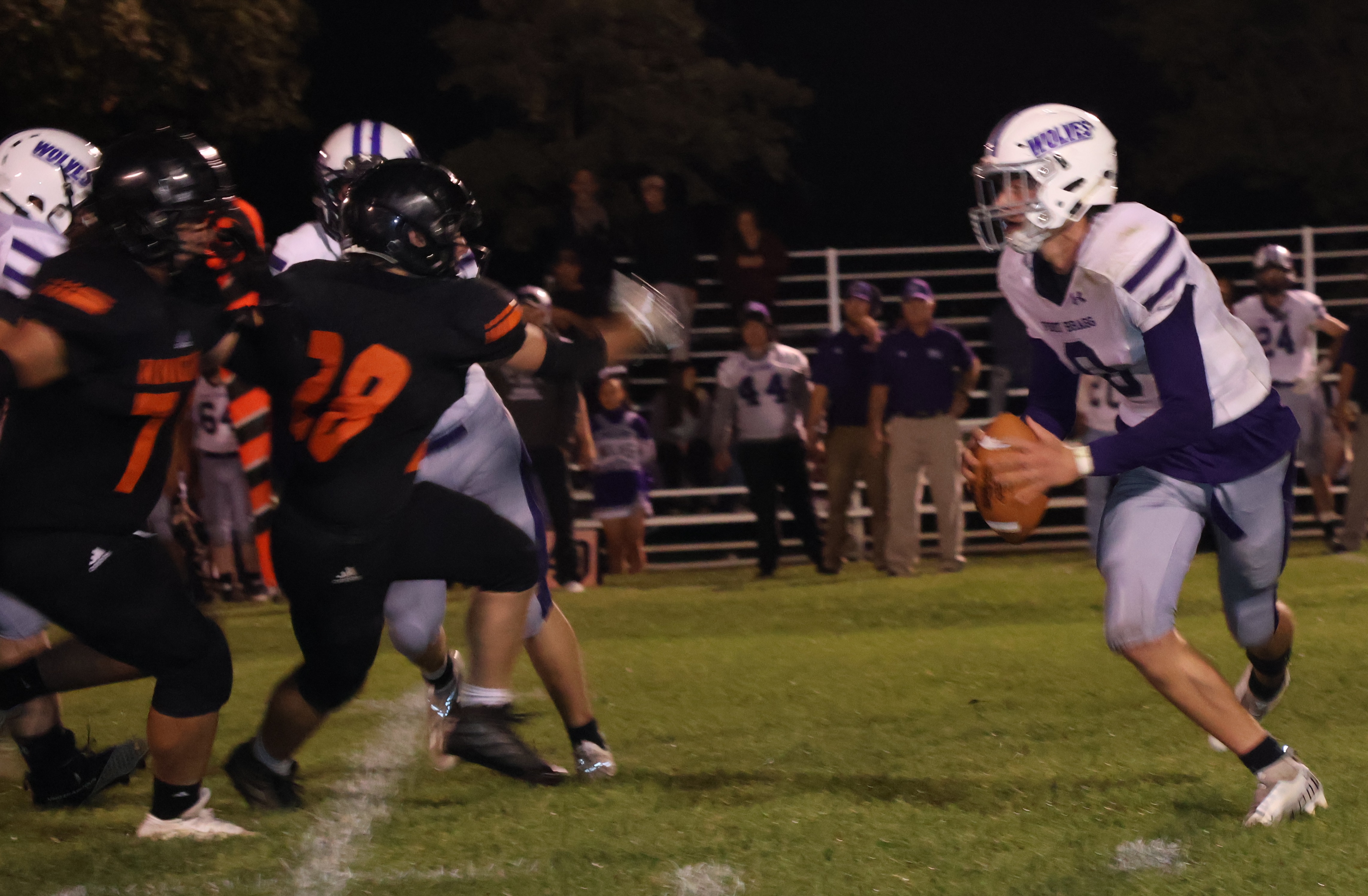 Kelseyville's Jon Dougherty (28) and Ty Steely break down the pass protection as Fort Bragg quarterback Chance Tager scrambles away from the pressure. (Photos by Brian Sumpter)