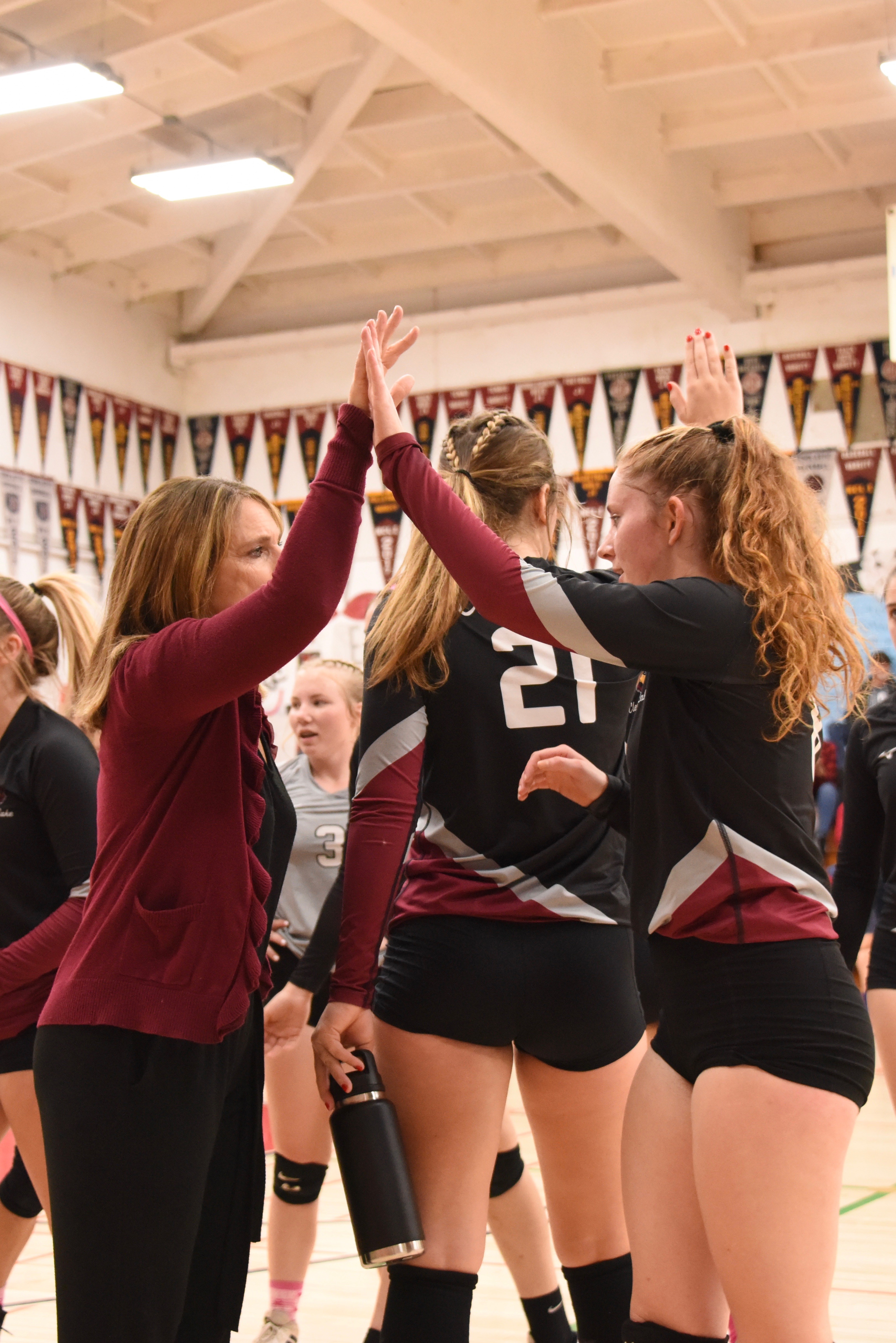 Clear Lake head coach Marci Psalmonds and senior Stella Hill exchange high-fives during a break in the action. (Photos courtesy of Trett Bishop)