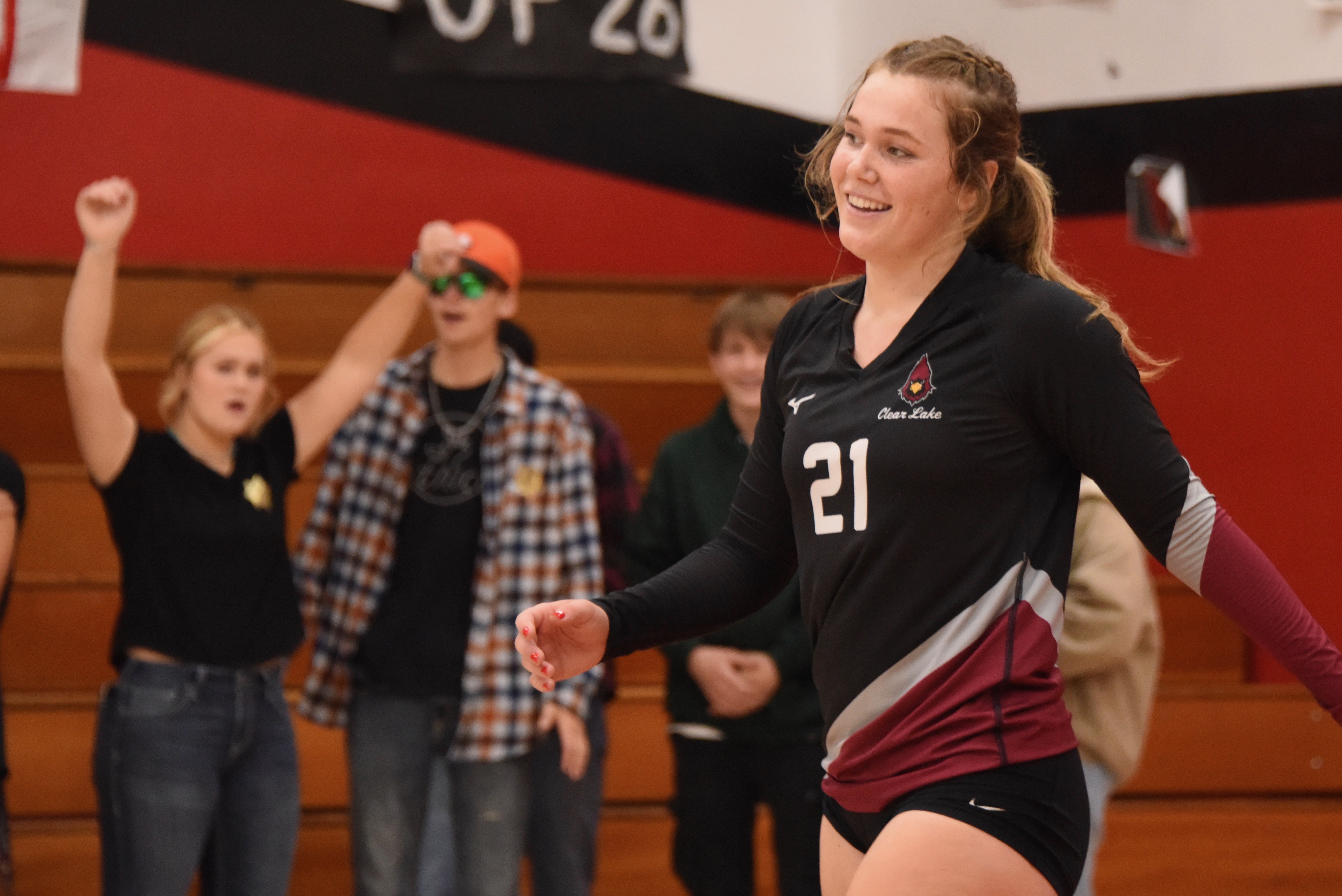 Clear Lake senior Abby Mertle enjoys the moment while sister Emma cheers her on from near the student rooting section Tuesday night. (Photos courtesy of Trett Bishop)