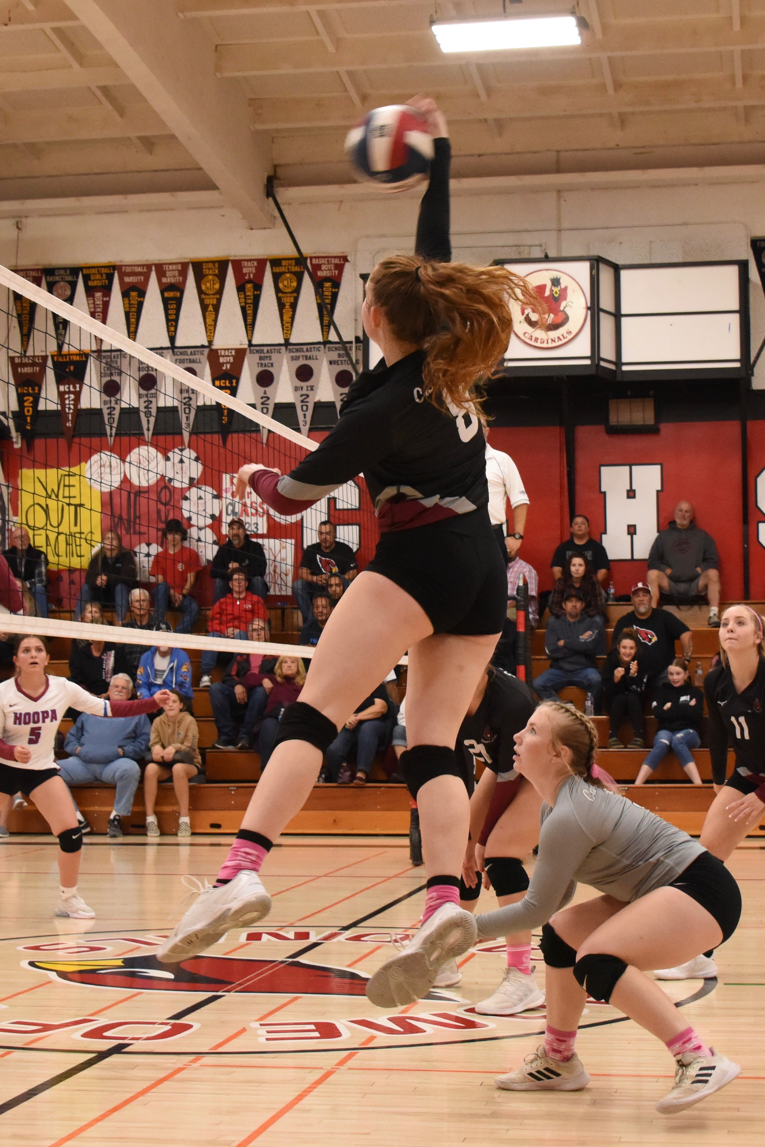 Outside hitter Stella Hill blasts one at the Hoopa defense as teammates Amber Smart and Sierra Bruch (11) look on. (Photos courtesy of Trett Bishop)