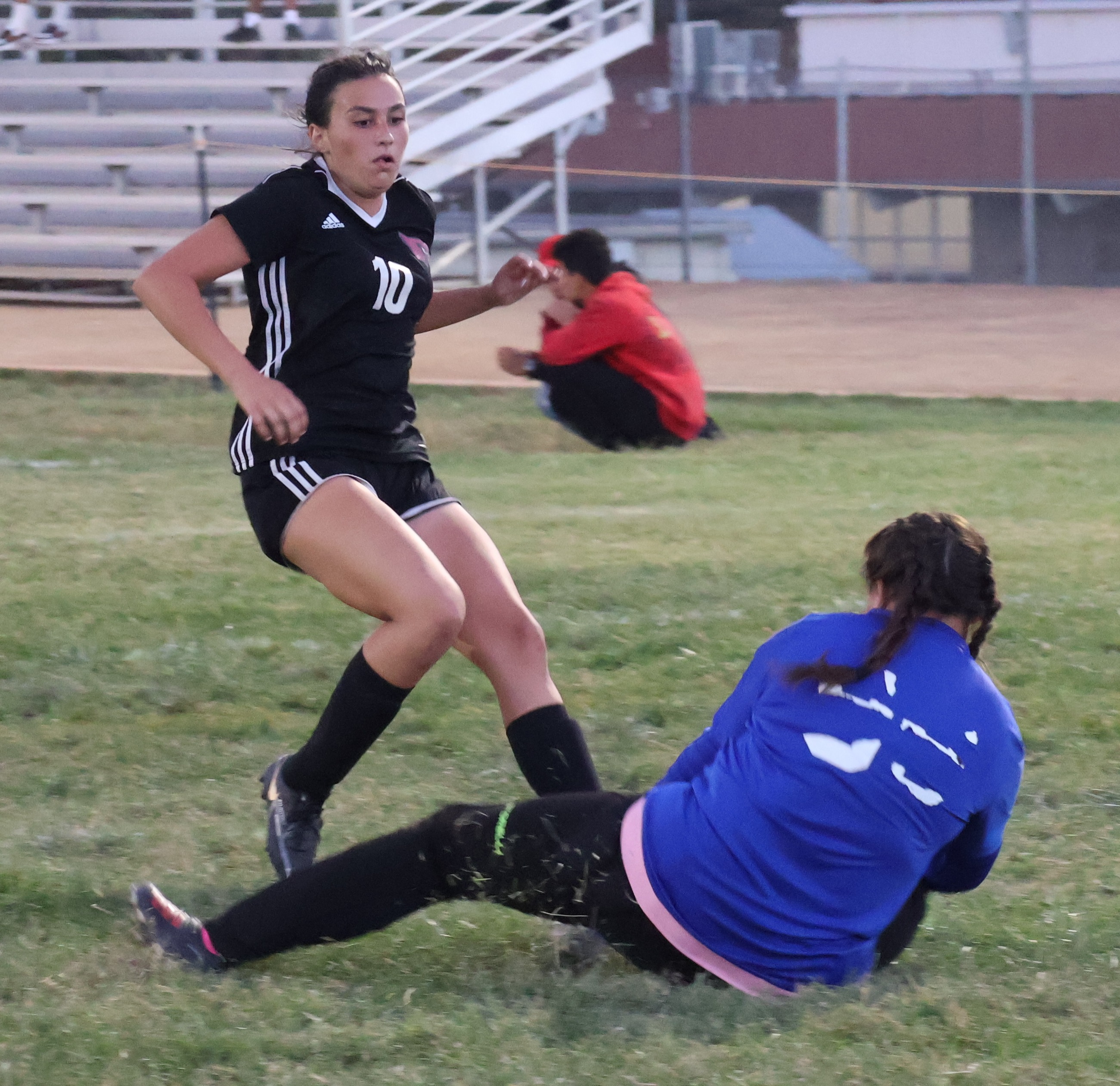 Middletown keeper Krystal Ocken covers up the ball before Clear Lake's Kam Cresto can get to it, one of Ocken's many saves on Tuesday night in Lakeport. (Photos by Brian Sumpter)