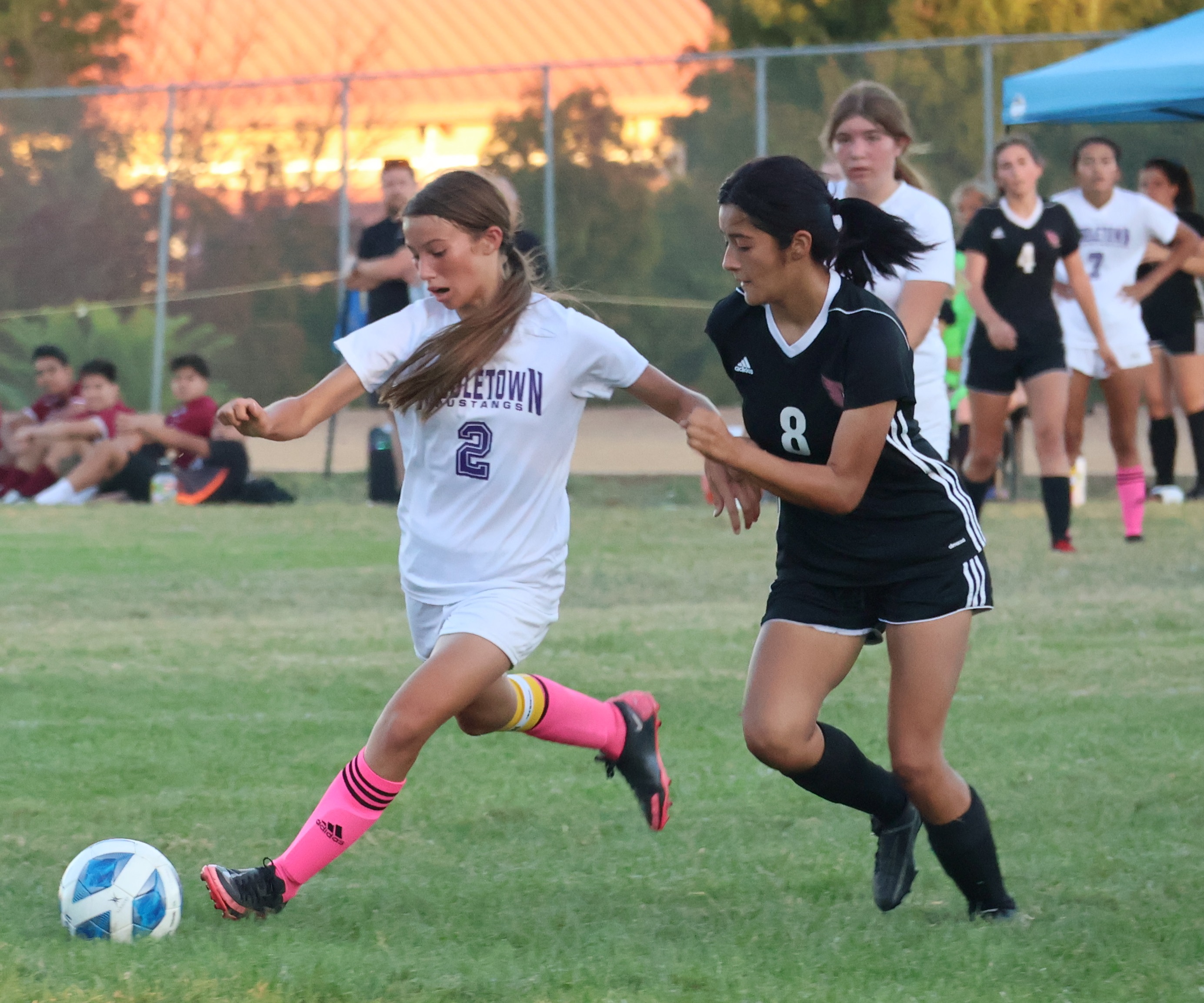 Middletown's Jenna Tufo works the ball down the field as Clear Lake's Anyssa Perez defends on the play. Tufo scored the Mustangs' lone goal in a 2-1 league loss to the Cardinals. (Photos by Brian Sumpter)